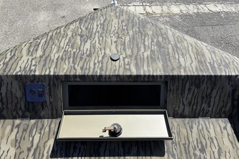 2026 SeaArk Shadow 19 V Center Console with camo pattern and open storage compartment.
