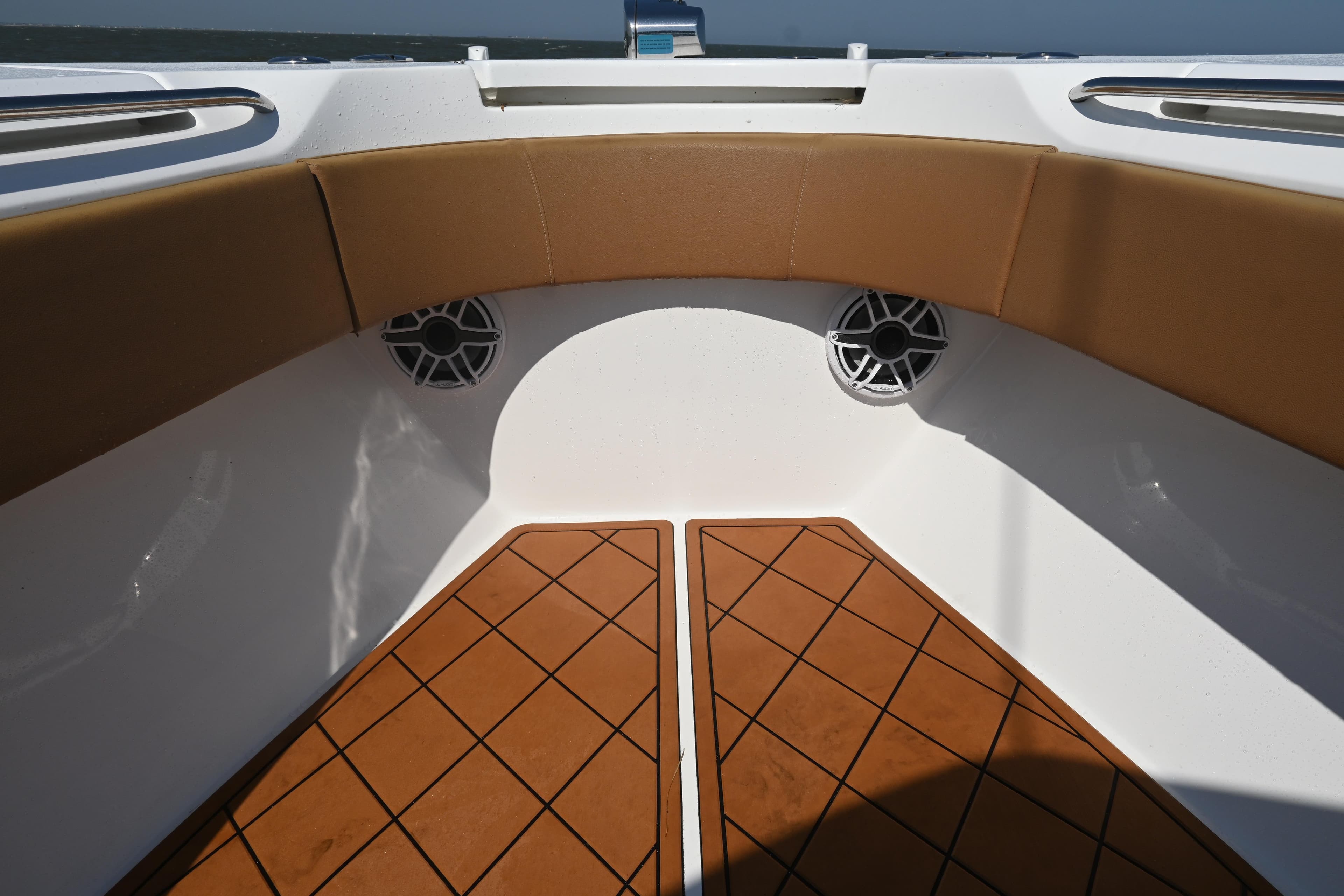 Interior of 2021 Cape Horn 32 T boat with cushioned seating and speakers.
