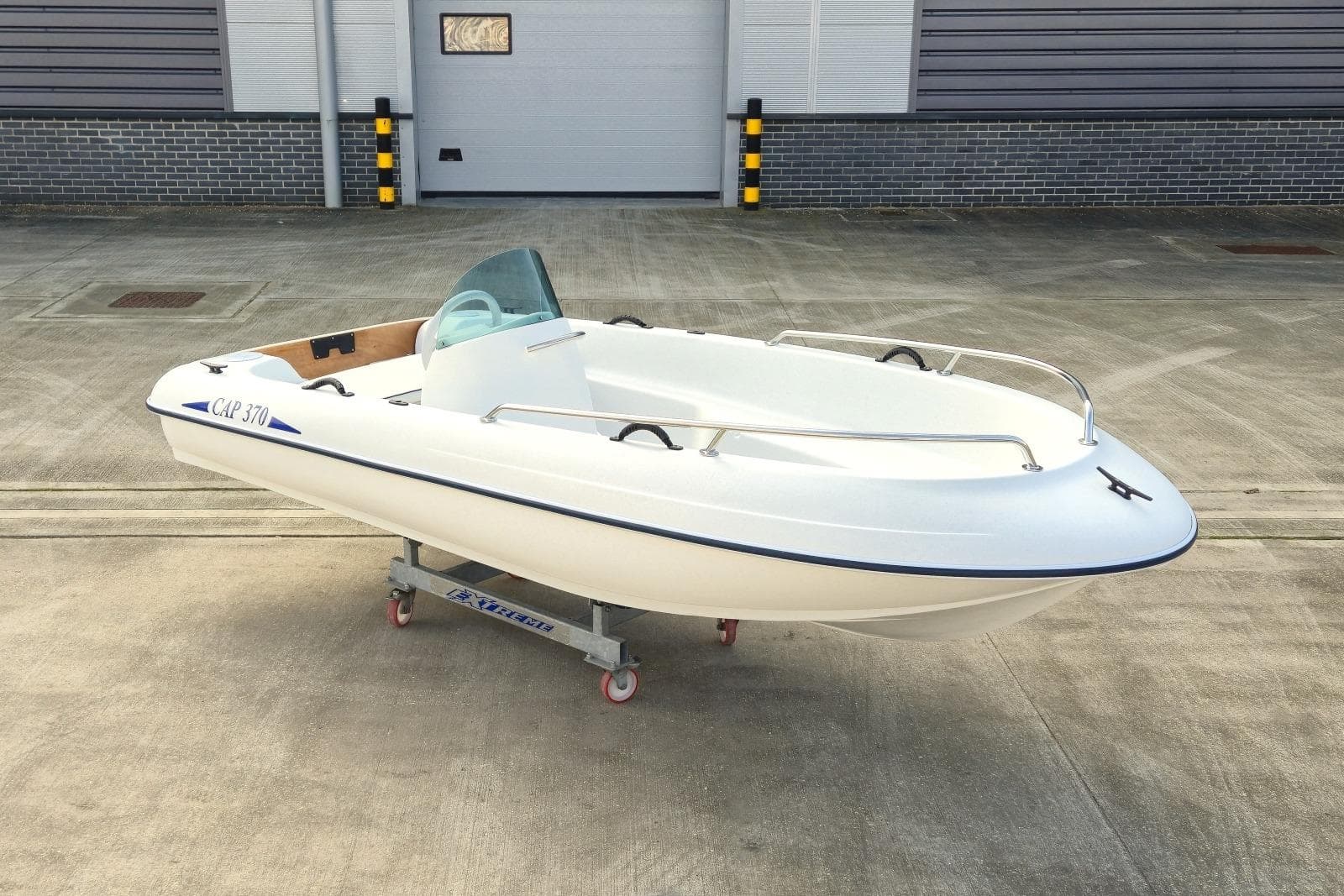 2023 Rigiflex CAP 370 Console Version boat on a trailer in an industrial setting.