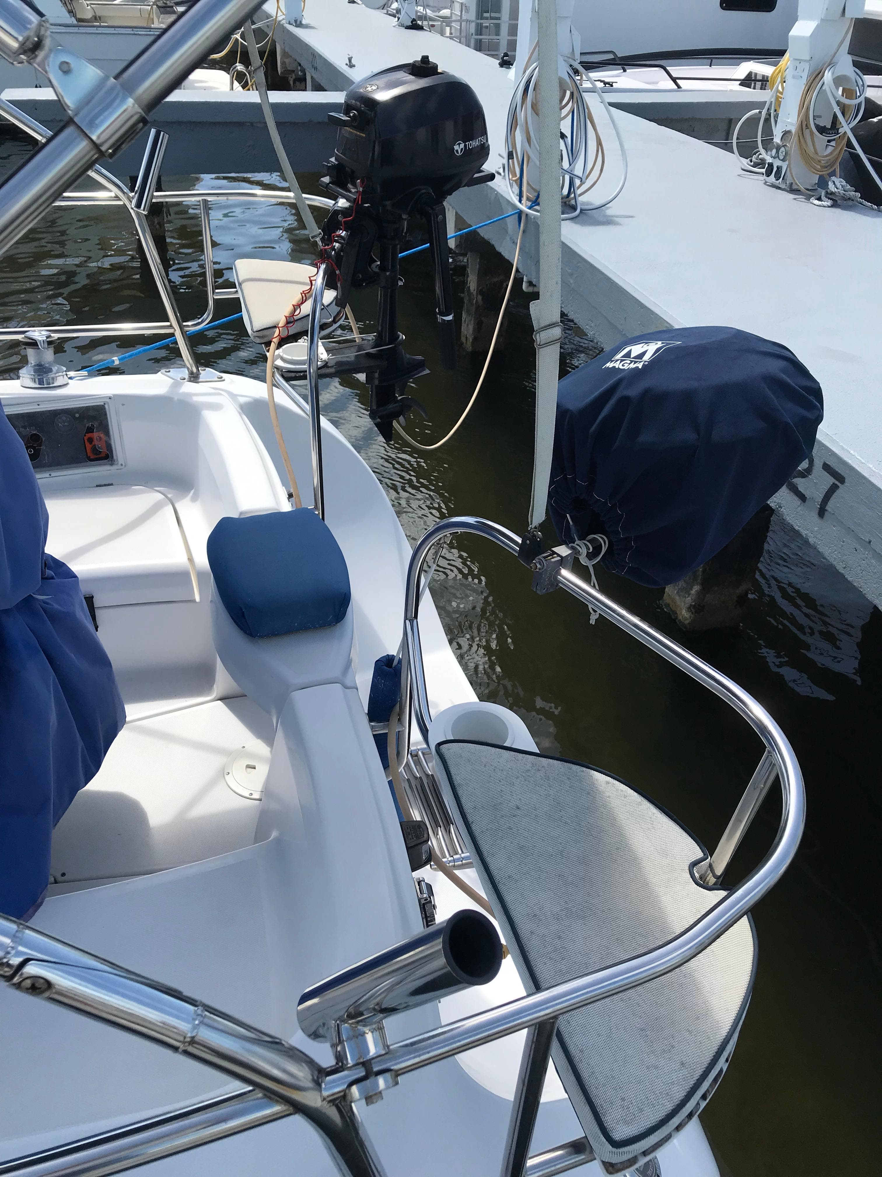2009 Hunter 310 sailboat cockpit with motor, docked at marina.