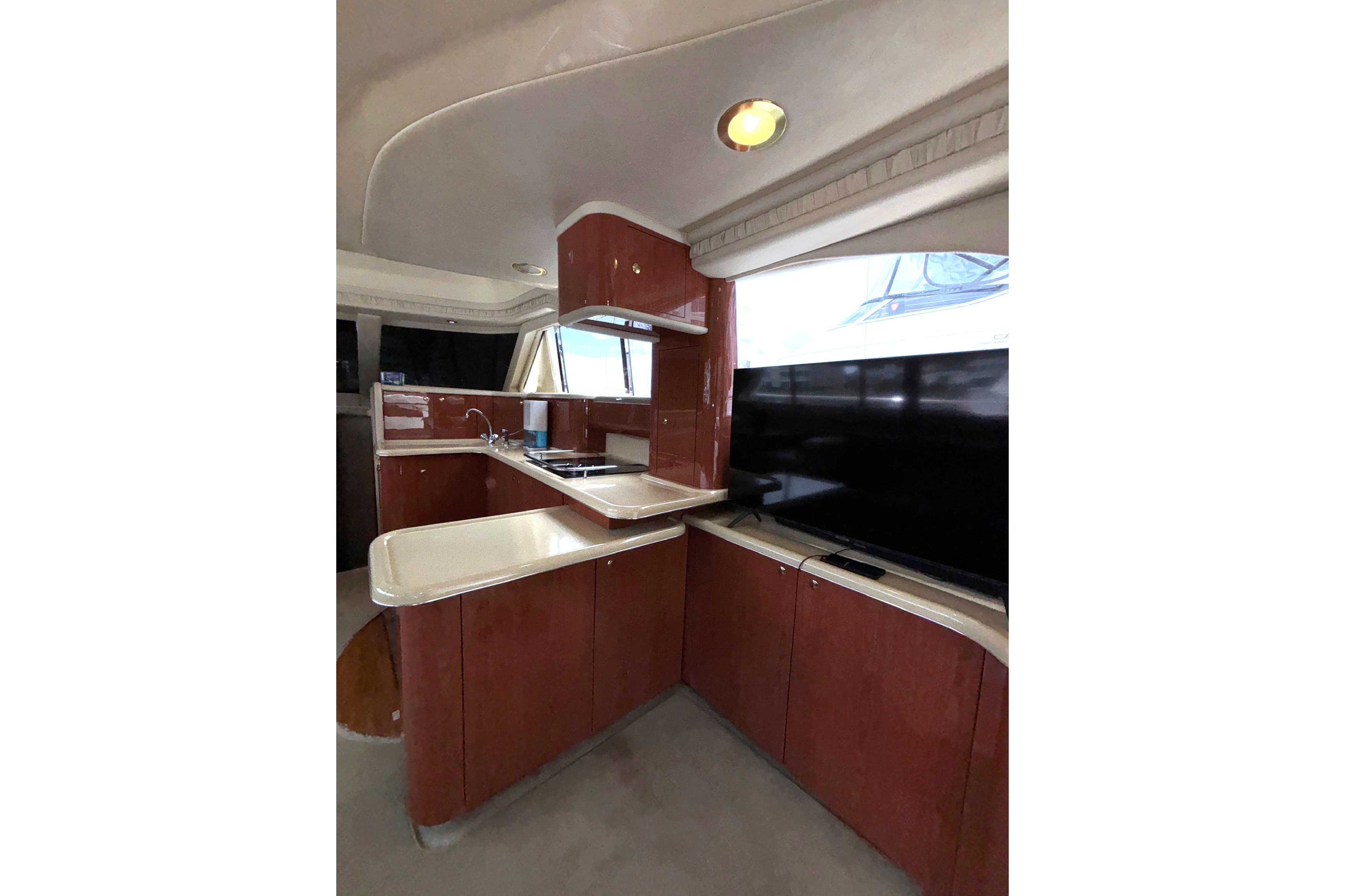 Interior of 1999 Sea Ray 480 Sedan Bridge yacht with modern kitchen and sleek cabinetry.
