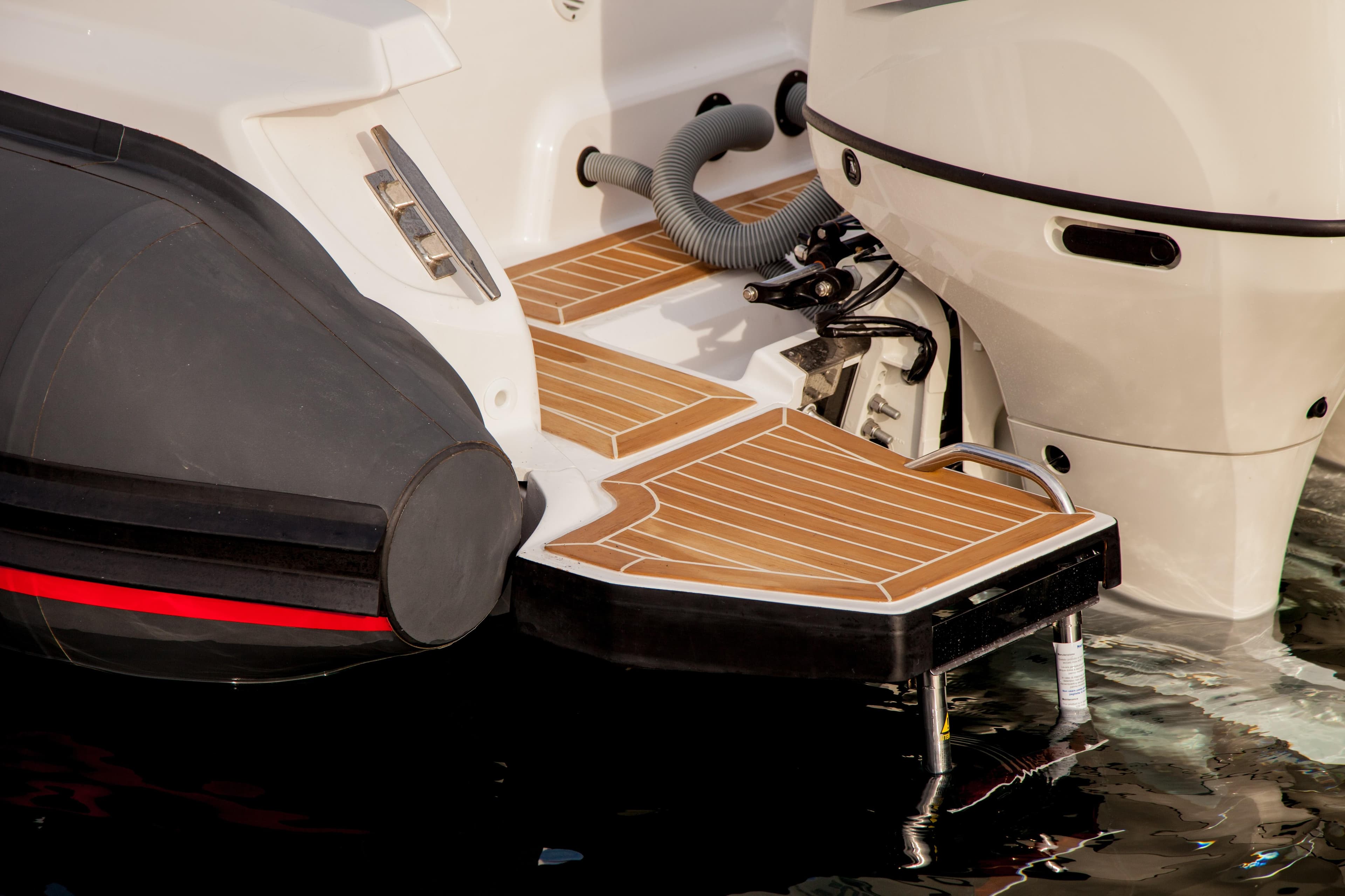 Zar Formenti 85 SL 2025 boat stern with teak deck and outboard motor.