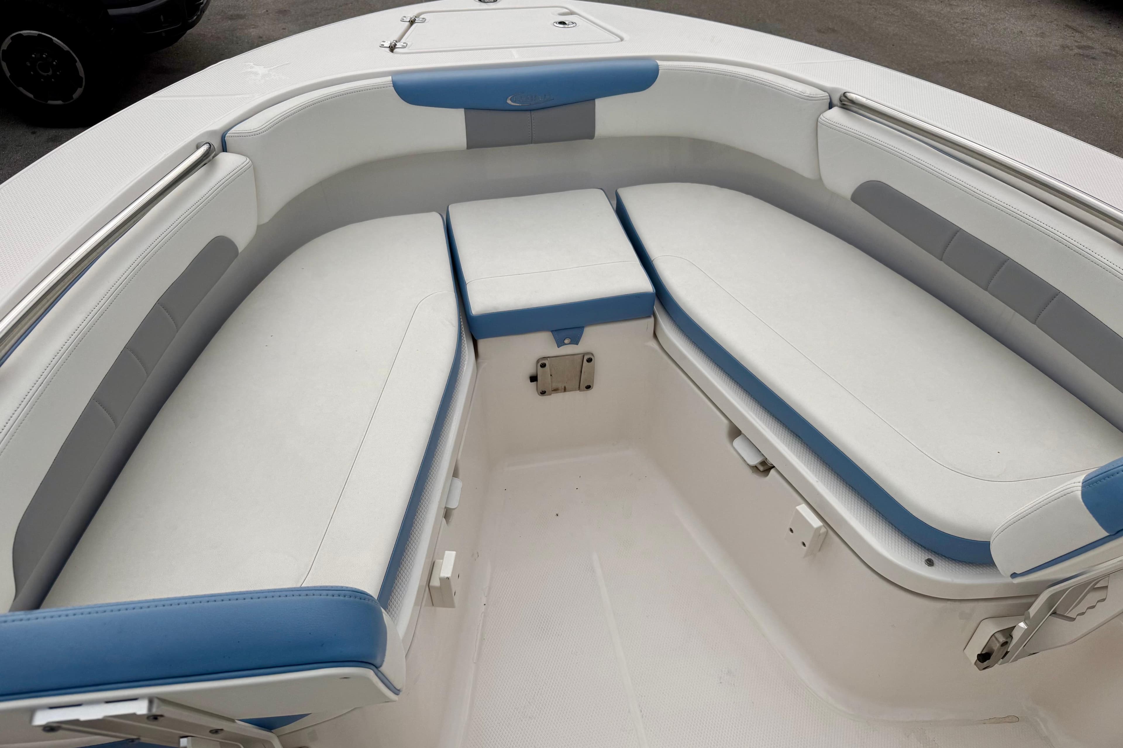 2023 Robalo R202 Explorer boat interior with white and blue cushioned seating.