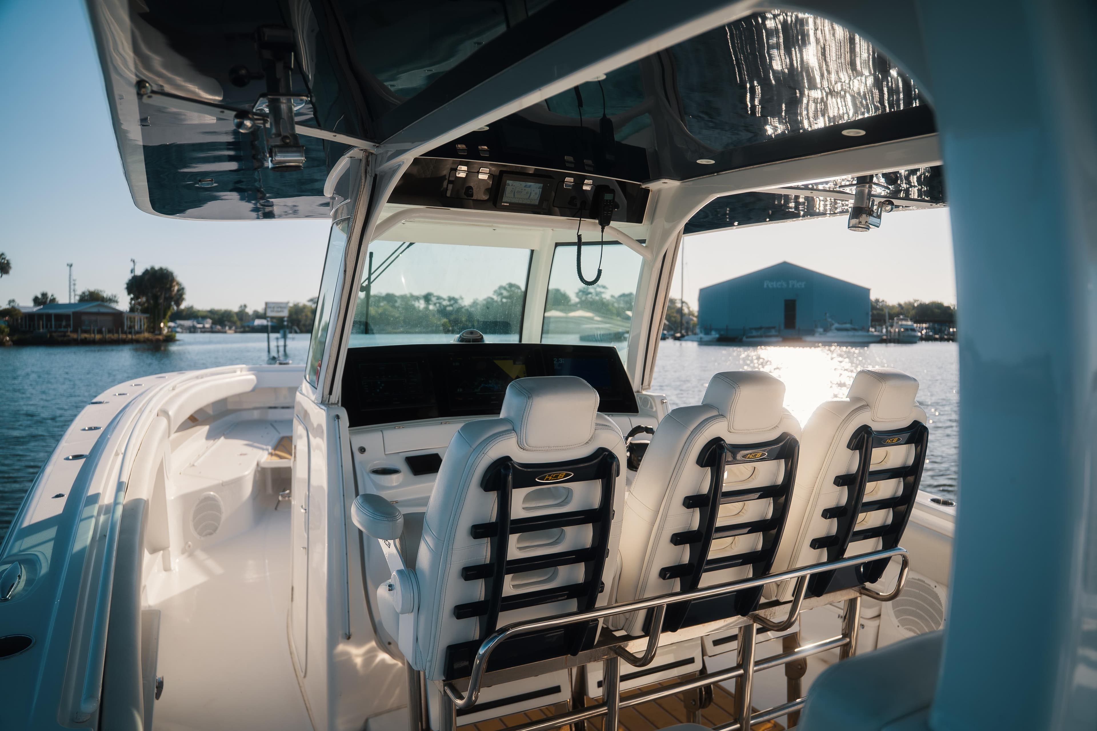 2019 HCB 42 Siesta boat interior with helm seats and waterfront view.