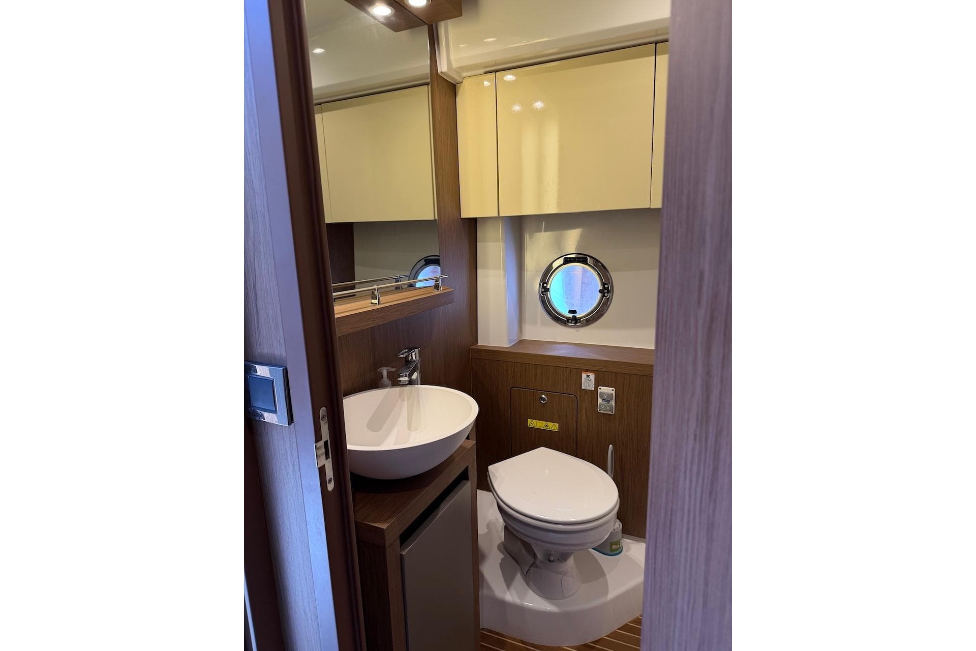 2018 Beneteau Gran Turismo 46 yacht bathroom with modern fixtures and porthole window.