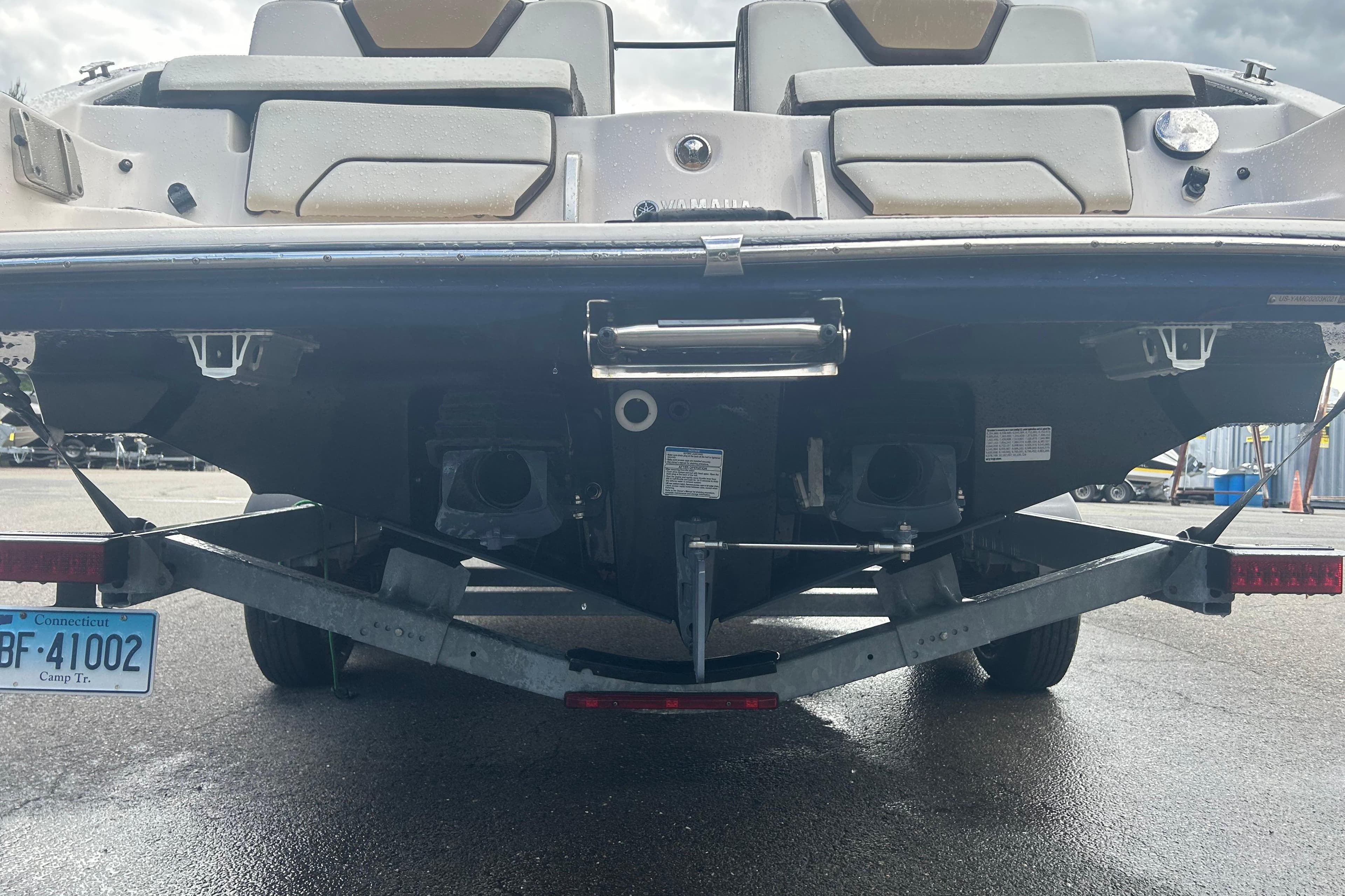 Rear view of 2021 Yamaha Boats 252SD on trailer, showcasing dual engines and swim platform.