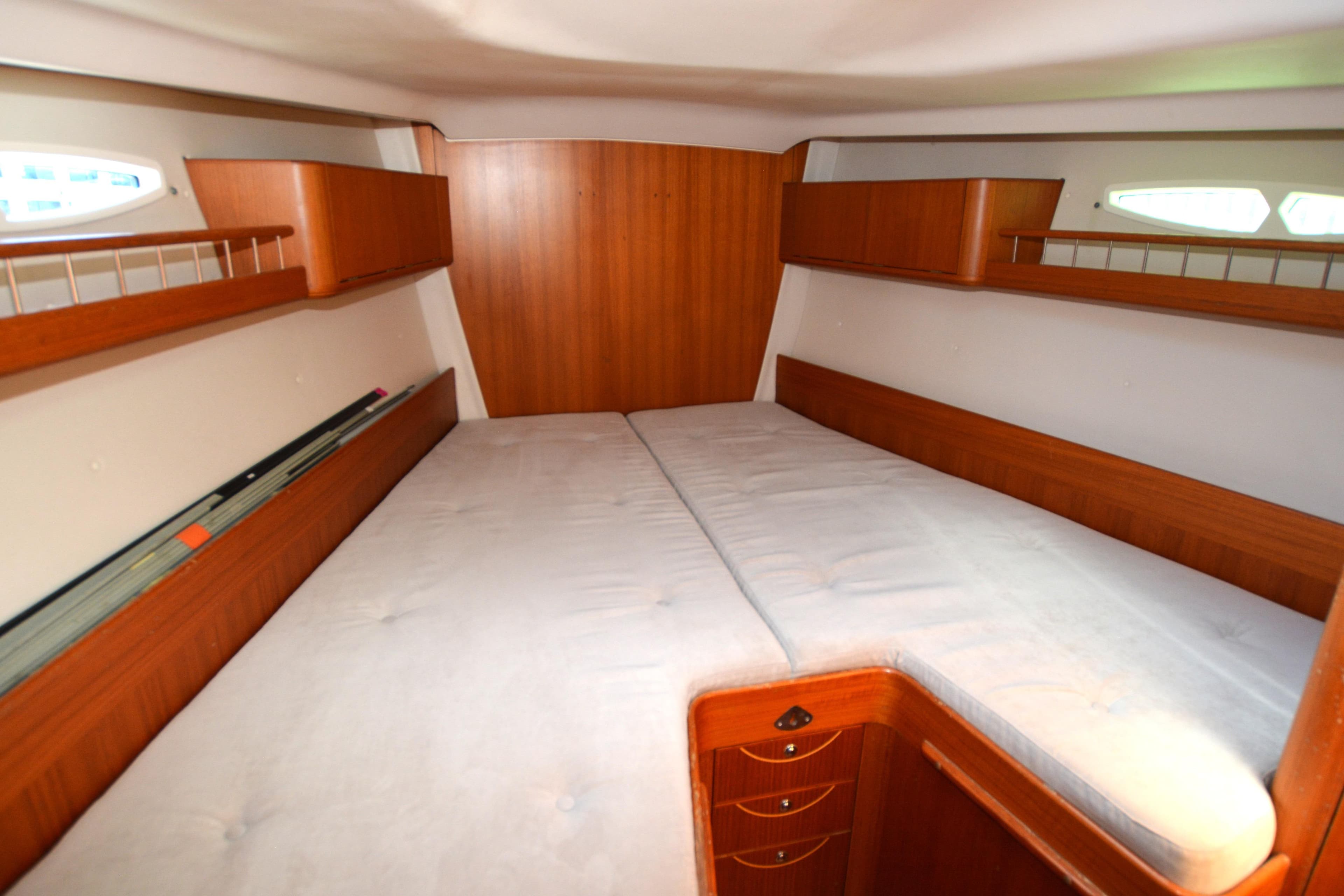 2004 X-Yachts X-46 cabin interior with wooden finish and spacious bedding.