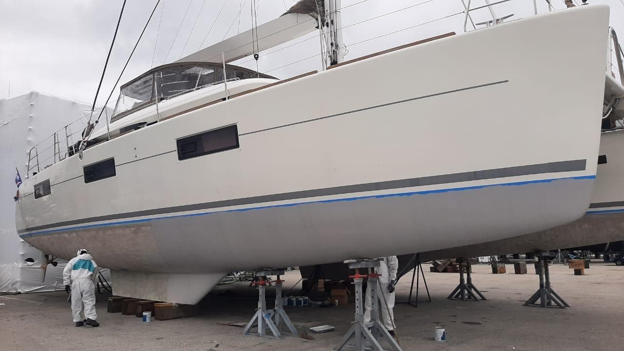 2017 Lagoon 620 catamaran on stands, undergoing maintenance in a shipyard.