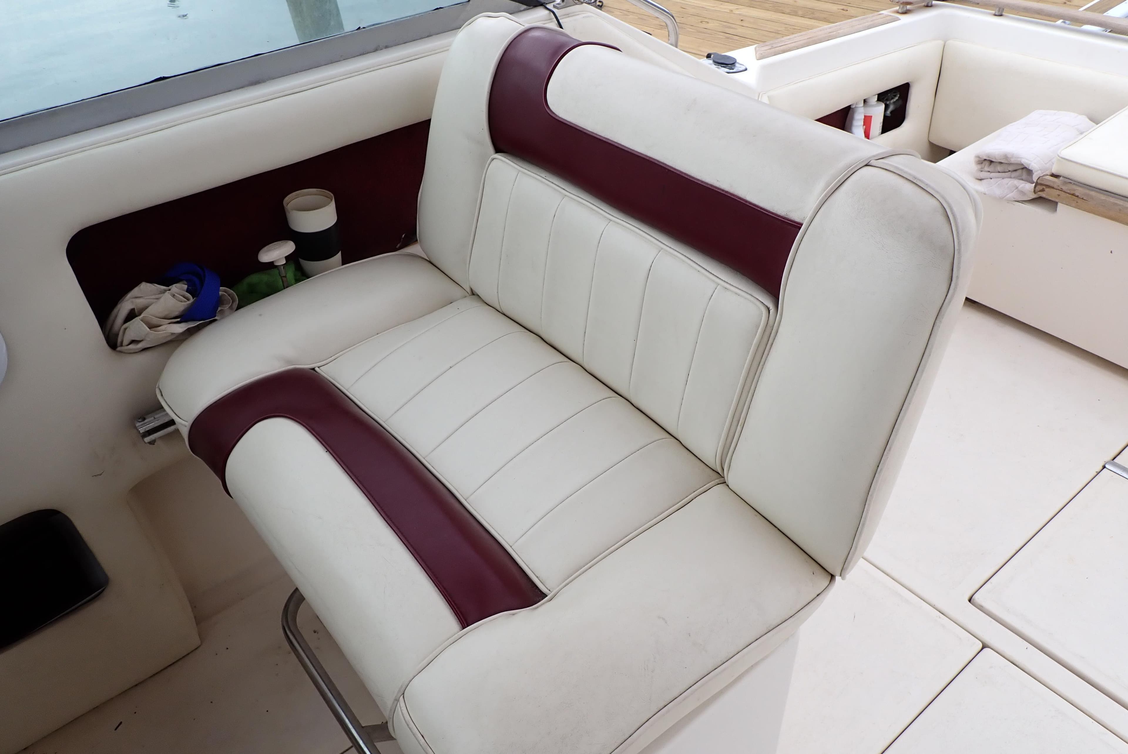 1987 Sea Ray 300 Weekender boat seat with white and maroon upholstery.