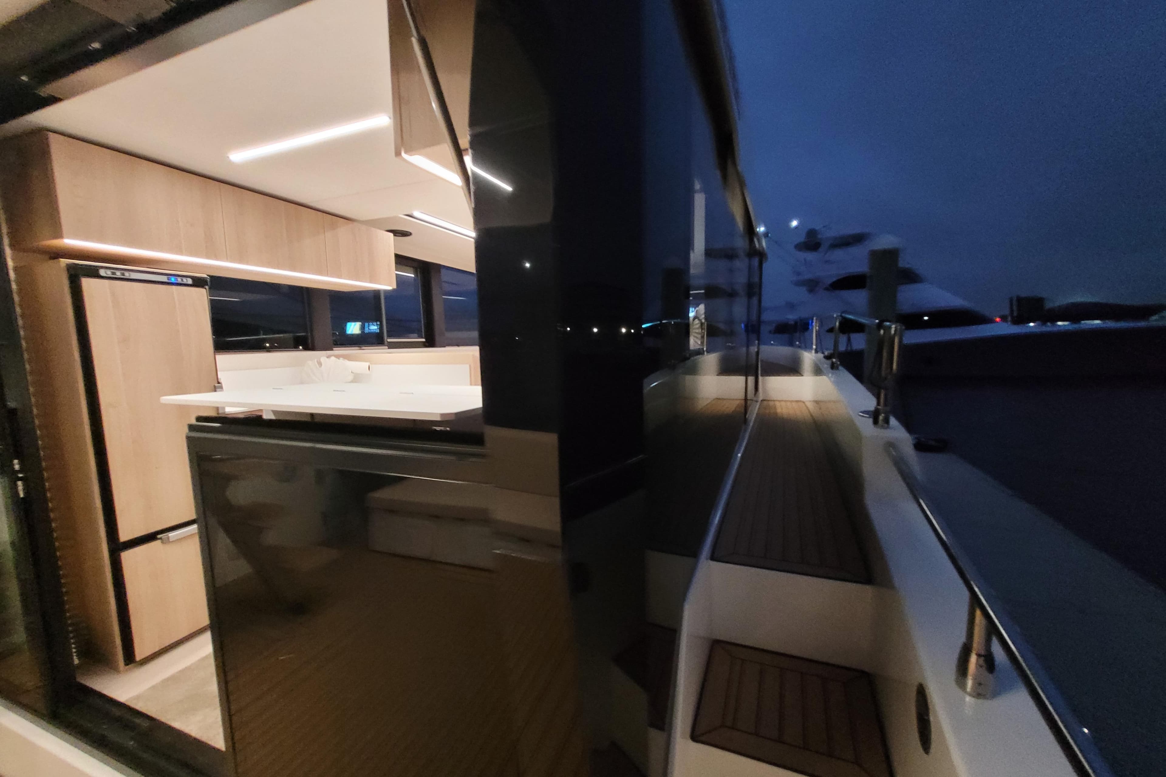 Modern interior of 2026 Cobra Yachts Seamaster 45, featuring sleek kitchen design at night.
