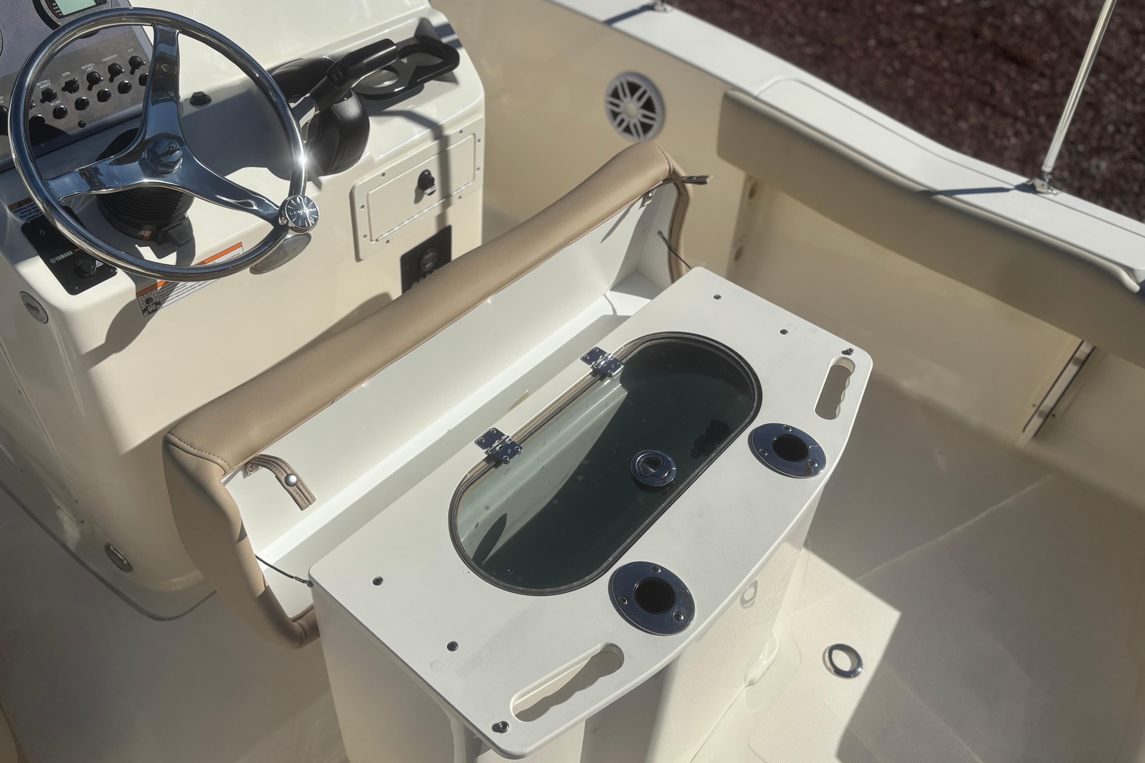 2025 Scout 195 Sportfish boat interior with steering wheel and livewell.