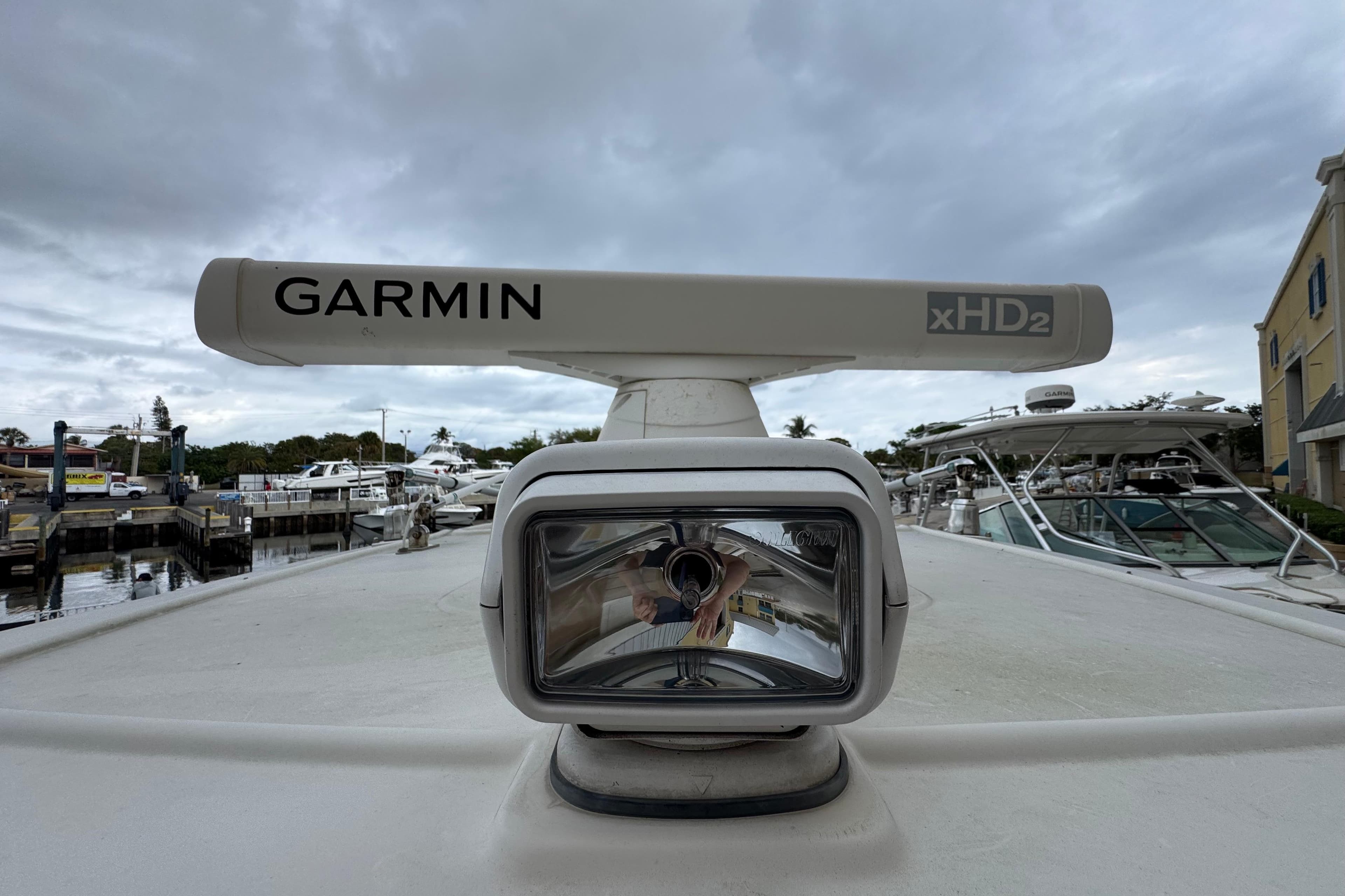 Garmin xHD2 radar on 2015 Sailfish 320 CC boat, docked under cloudy skies.