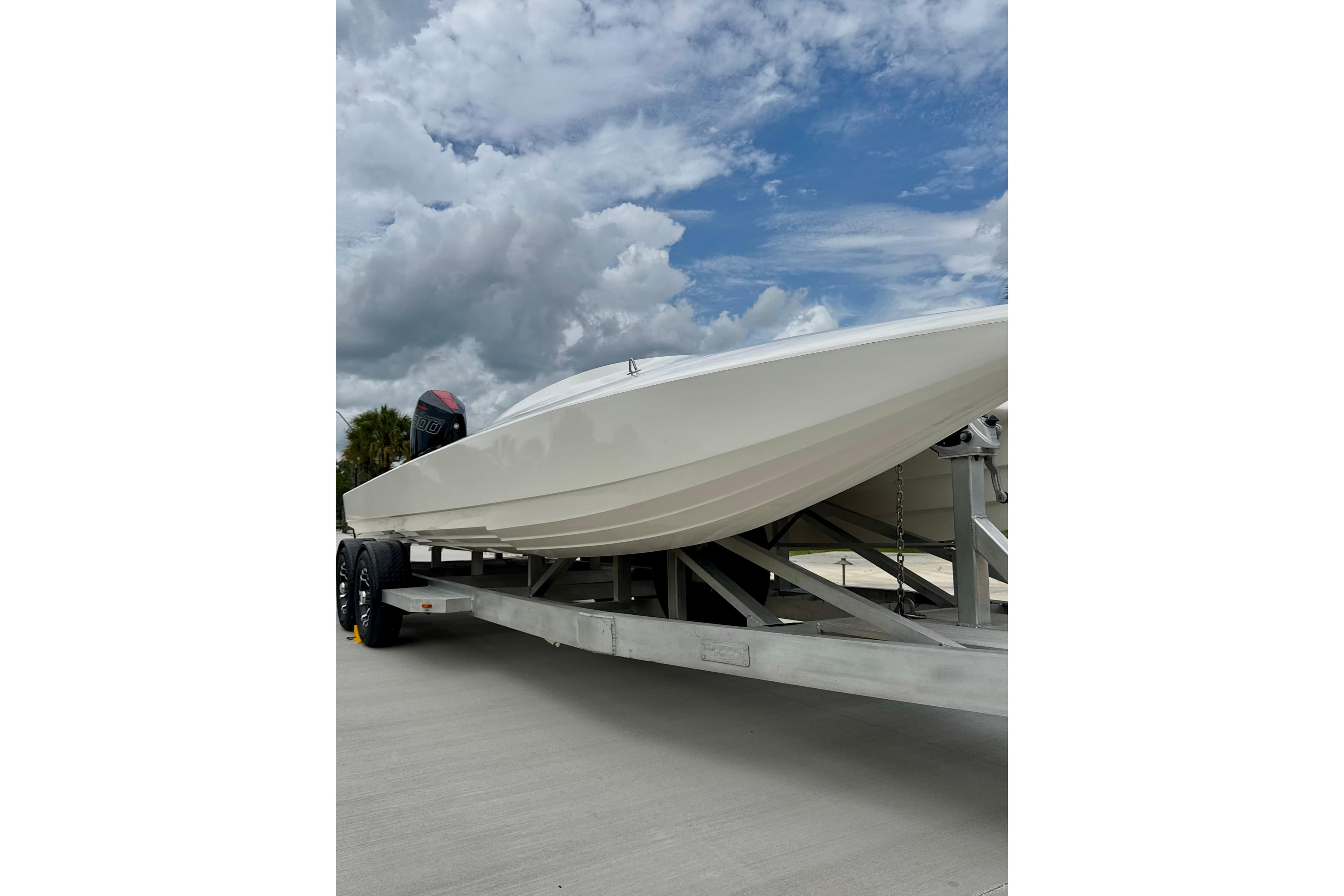2016 Argo 23 boat on trailer under cloudy sky.