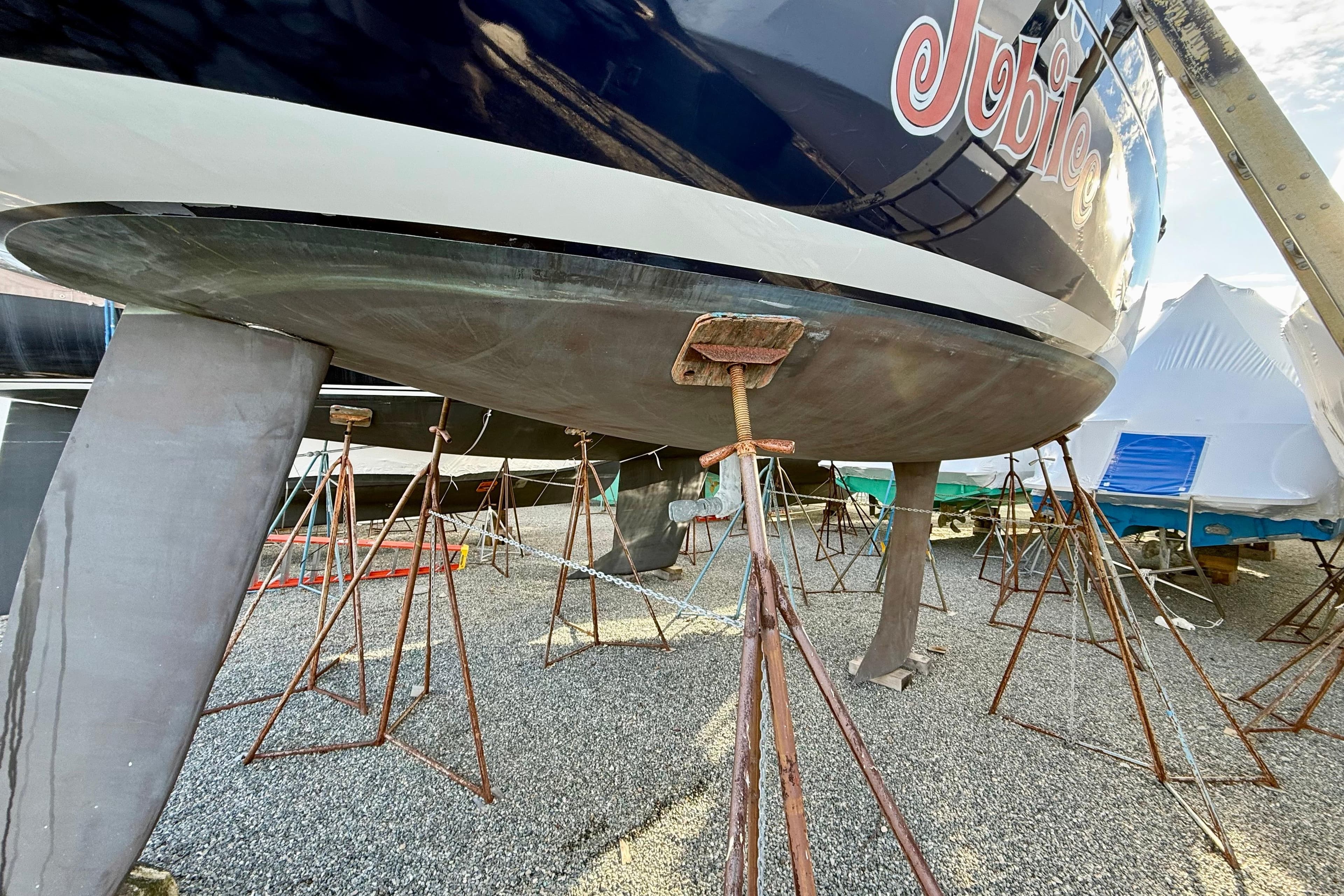 Beneteau First 36.7 sailboat from 2005 on stands, hull view.