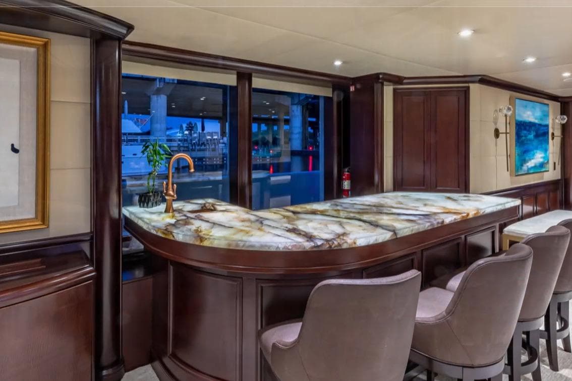 Luxurious interior of 1988 Van Mill 143 Tri-Deck Motor Yacht with elegant bar and seating.