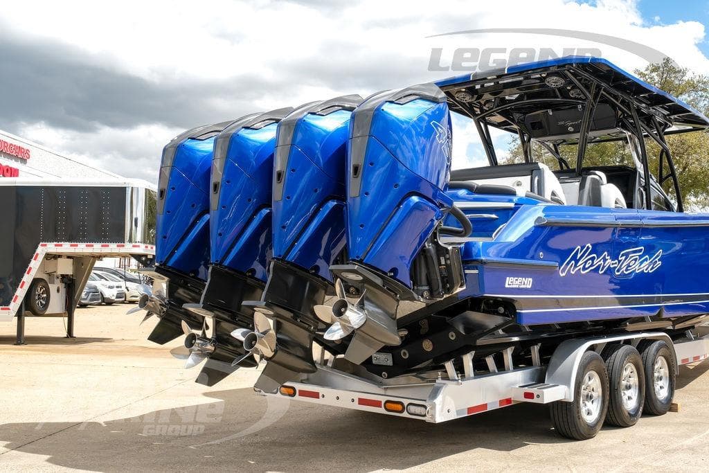 2023 Nor-Tech 390 Sport Center Console boat with triple engines on a trailer.
