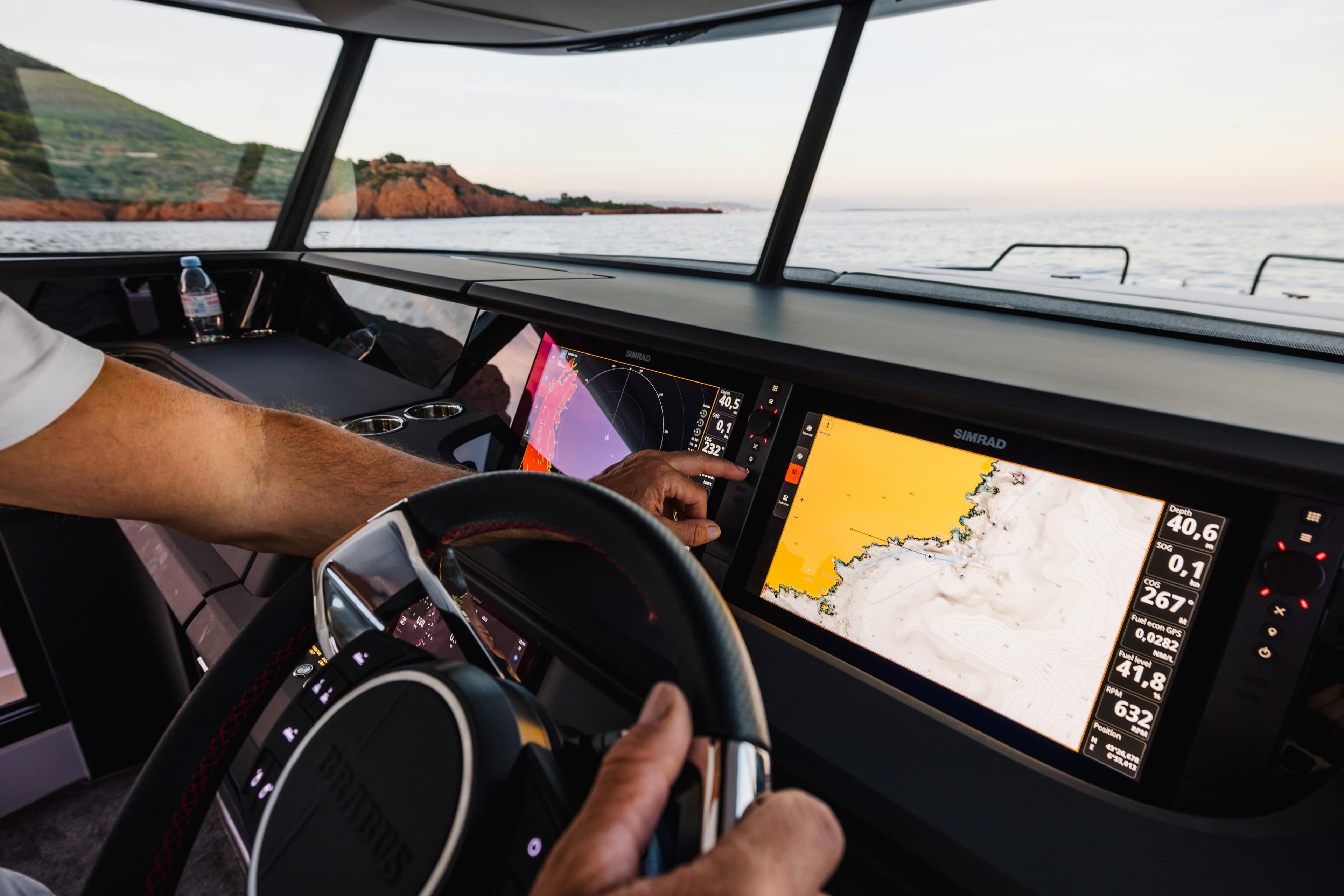 Helm of 2026 Axopar 45 XC Cross Cabin with advanced navigation displays.