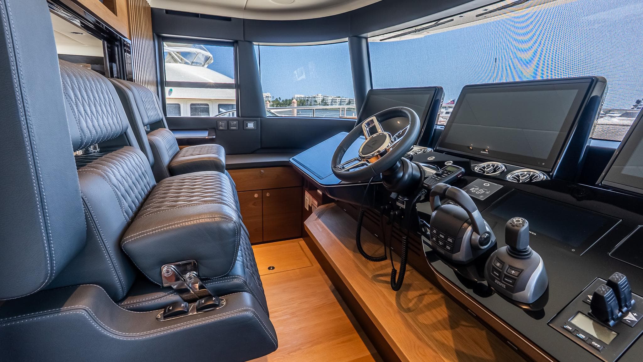 2024 Absolute 68 NAVETTA yacht cockpit with leather seats and advanced navigation controls.