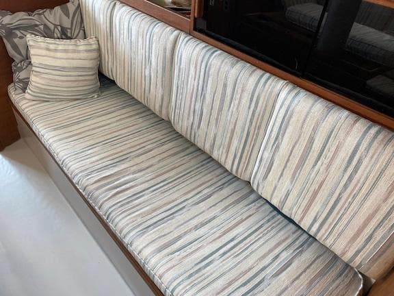 Striped upholstery on a 1979 Bayfield 29 boat interior with matching pillow.
