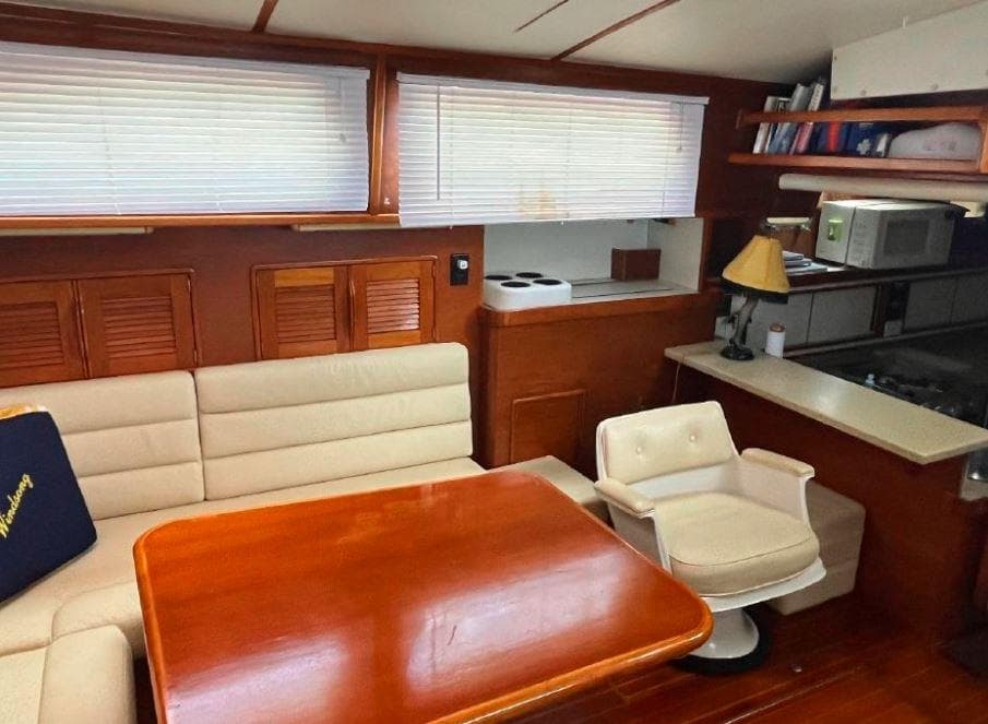 Cozy interior of 1990 Irwin 54 yacht with dining area and kitchenette.
