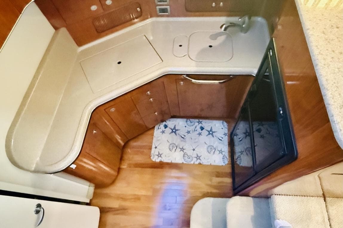 2004 Sea Ray 390 Motor Yacht kitchen with wood cabinetry and compact design.