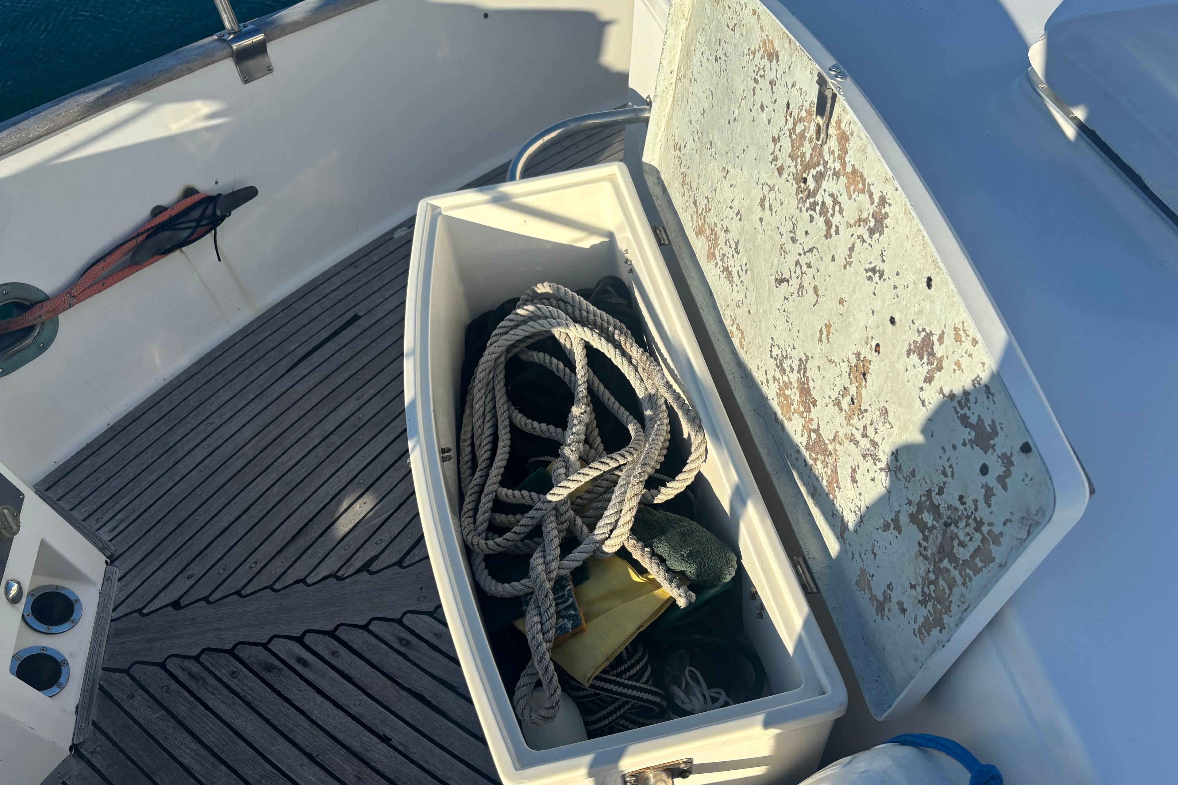 Open storage compartment on 1989 Grand Banks 46 Classic boat with ropes inside.