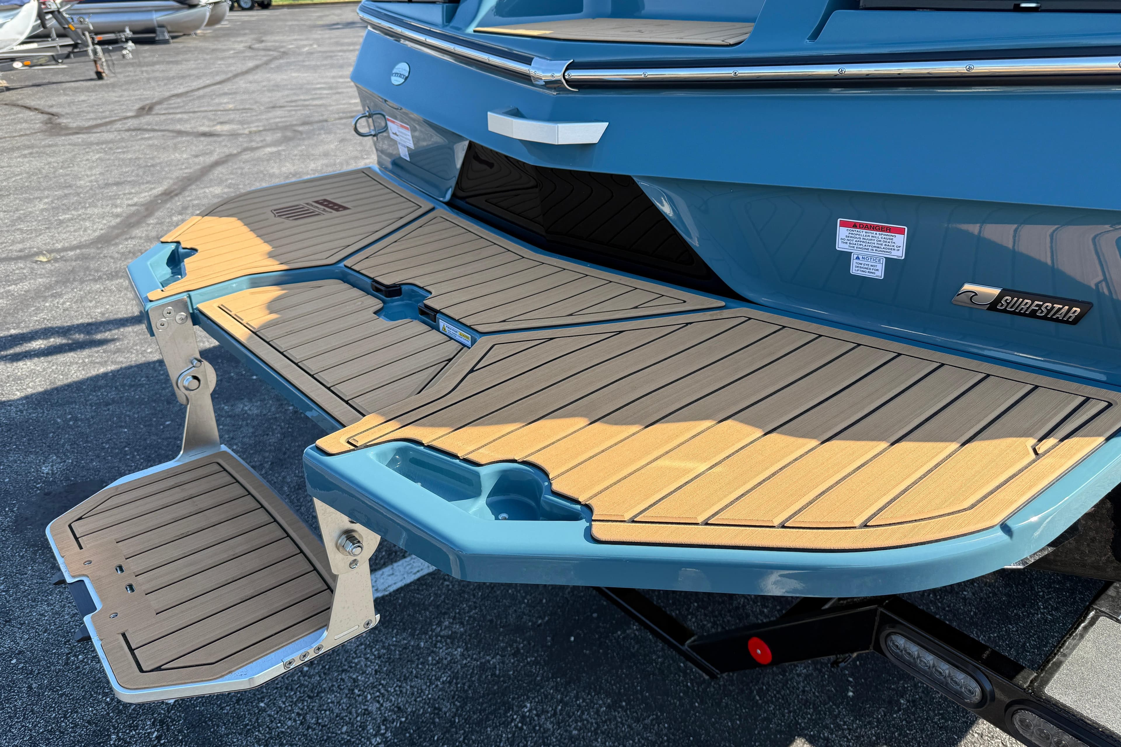 2025 MasterCraft XT24 boat with teak swim platform and SurfStar technology.