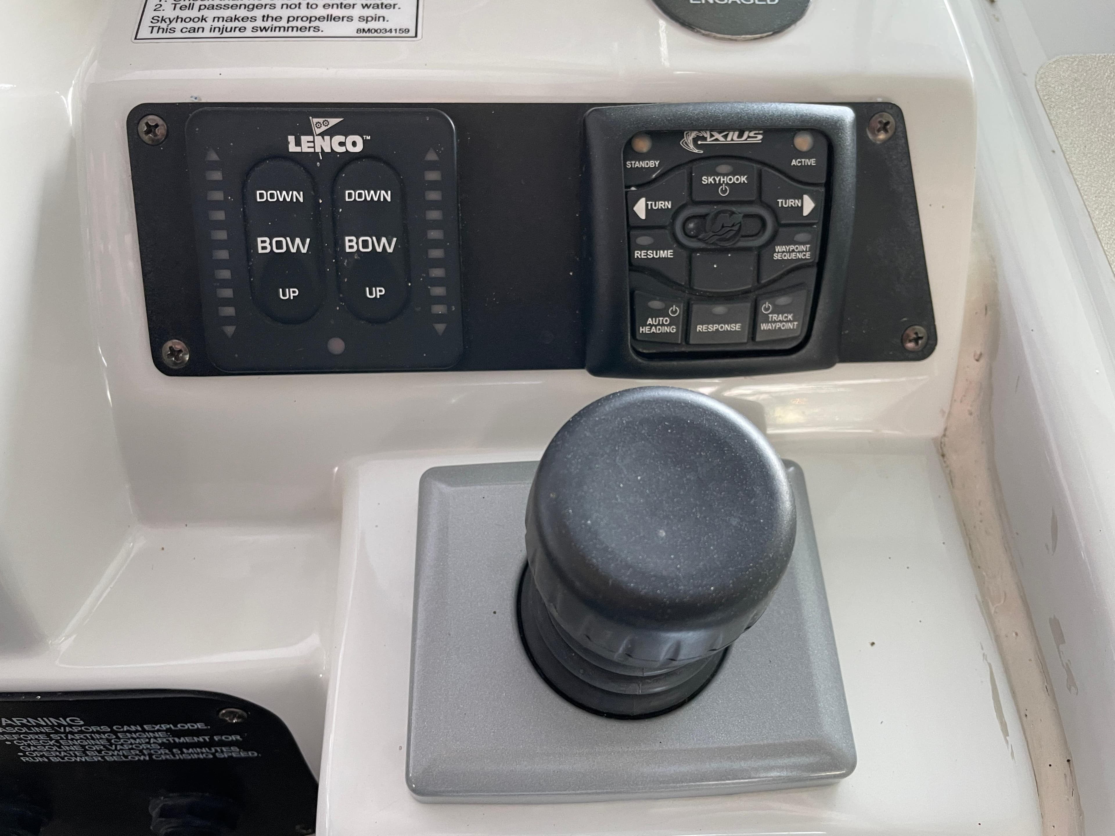 Control panel of a 2009 Crownline 340 CR boat with joystick and trim tabs.