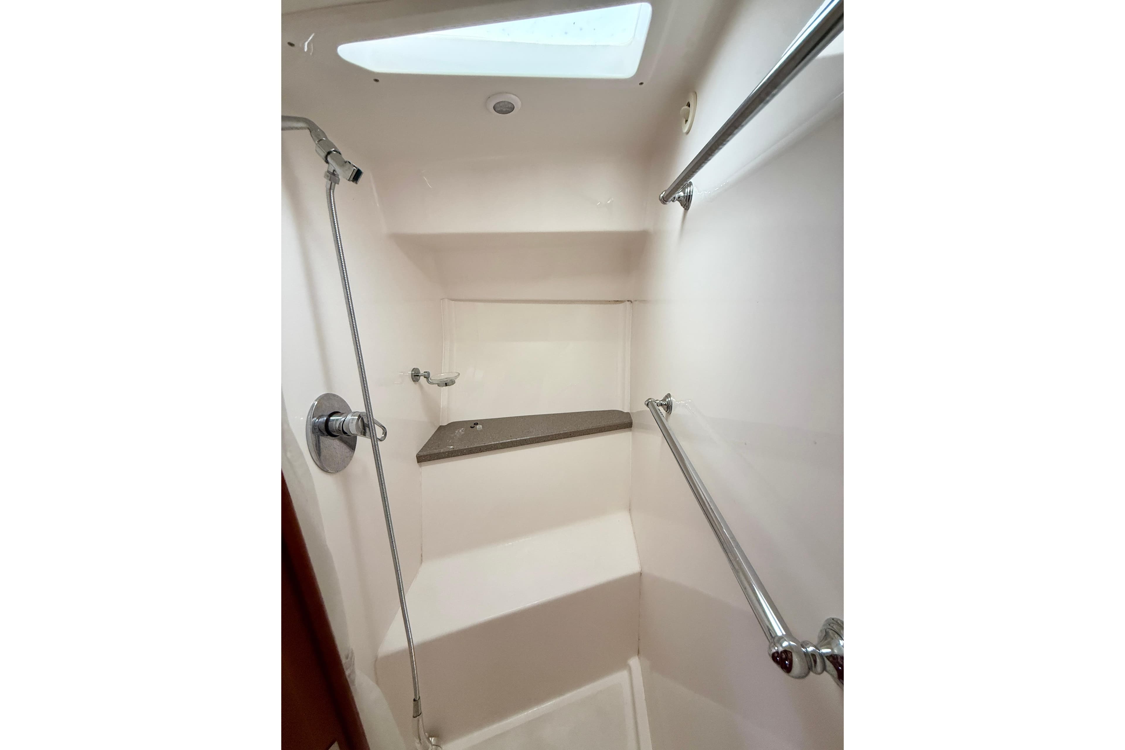Shower area in 2012 Regal 42 Sport Coupe yacht with skylight and chrome fixtures.