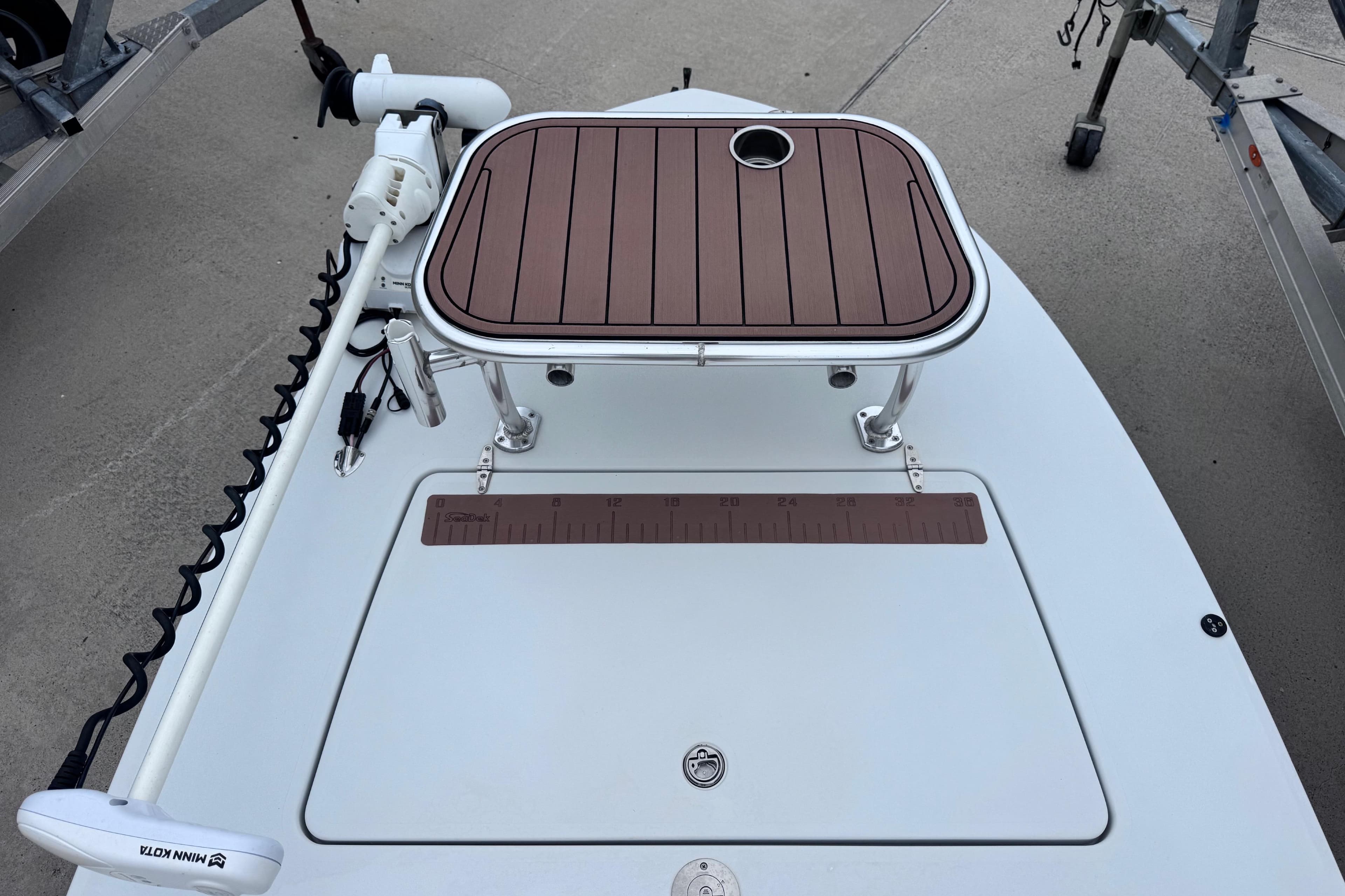 2016 East Cape Fury boat deck with trolling motor and measuring ruler.