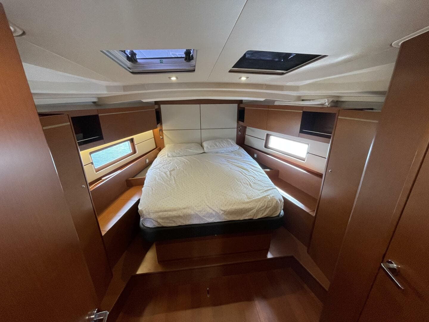 Luxurious cabin interior of 2020 Beneteau Oceanis 46.1 yacht with double bed and wood finish.