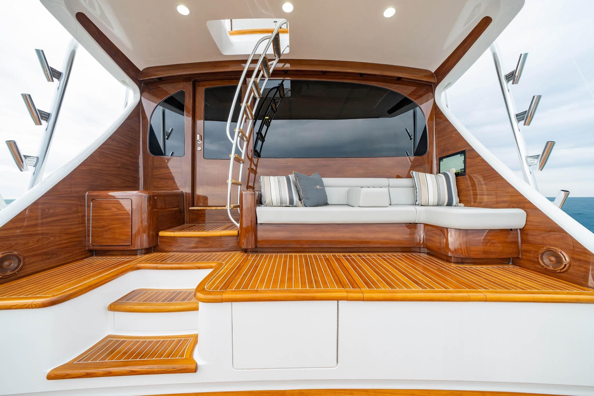 Luxurious 2026 Viking 82 Convertible yacht deck with elegant wood finish and plush seating.