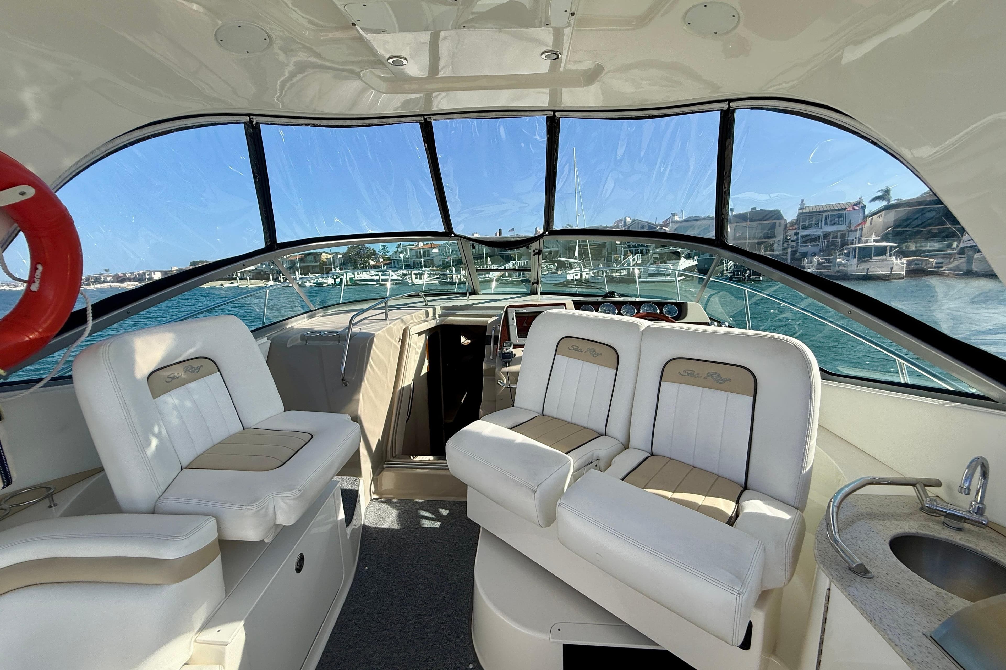 Interior view of 2009 Sea Ray Sundancer 350 yacht with white seating and ocean backdrop.
