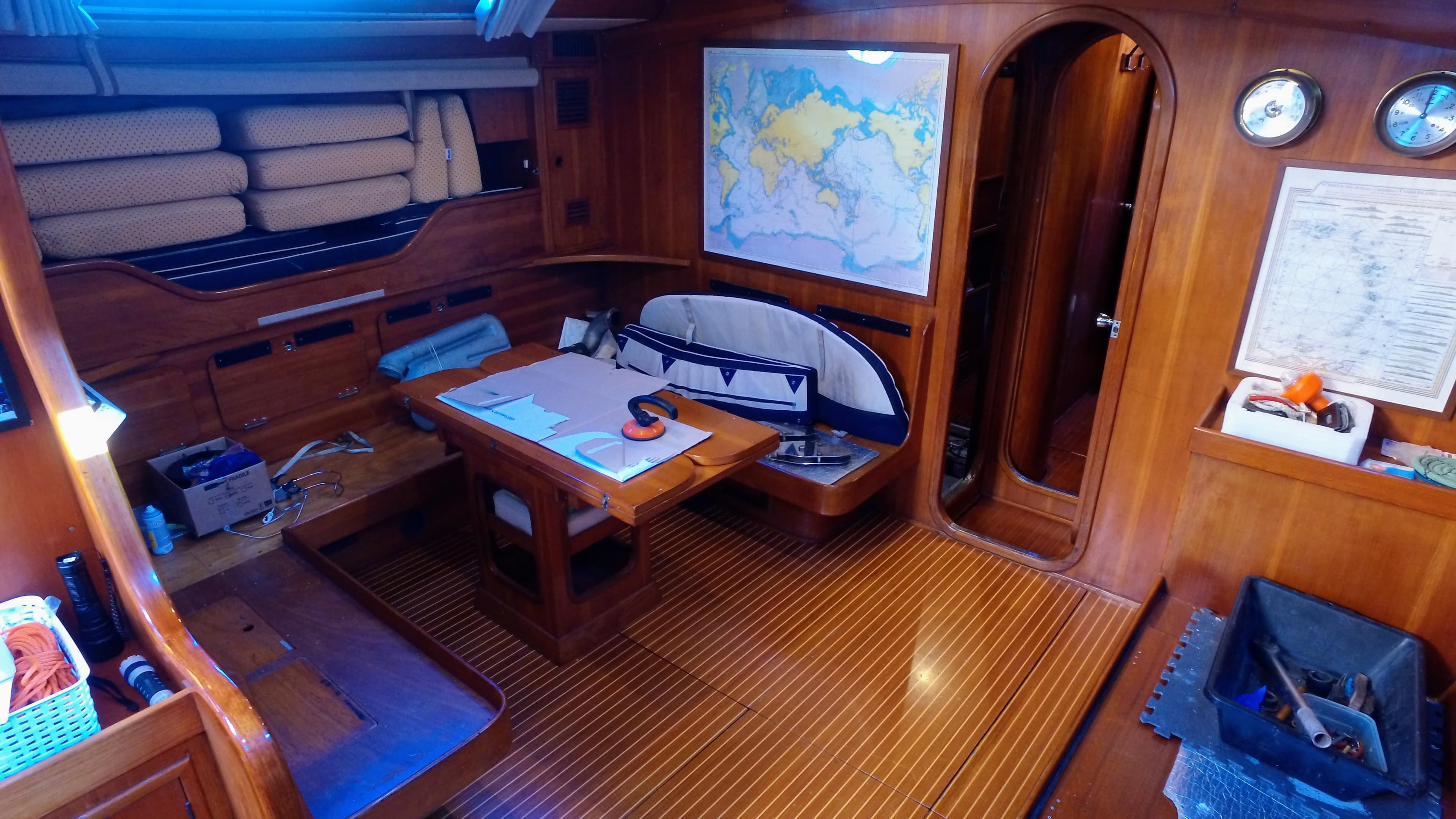 Interior of 1975 Nautor Swan 65 yacht with wooden furnishings and navigation area.