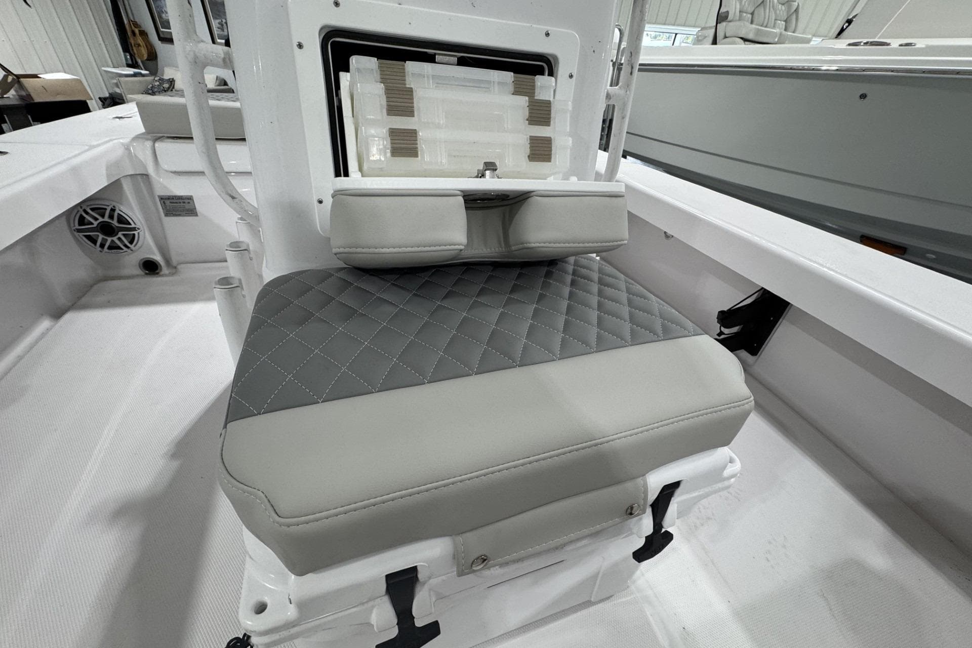 2026 Action Craft 20 Flatsmaster boat seat with quilted gray upholstery and storage compartment.