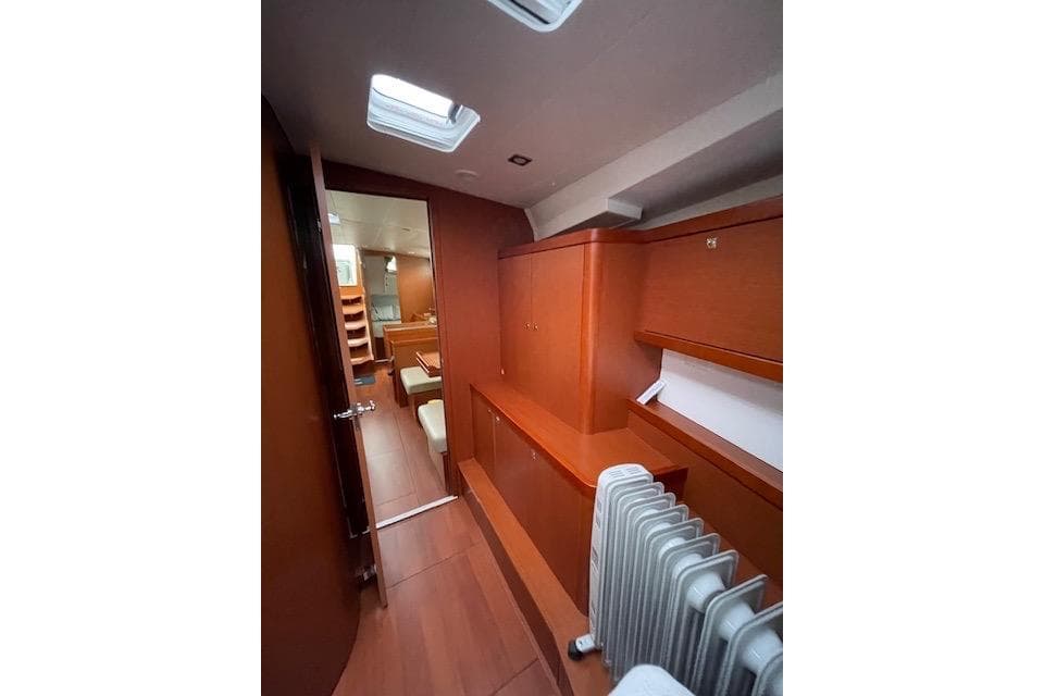 Interior of 2018 Beneteau Oceanis 45 yacht, featuring wooden cabinetry and modern design.