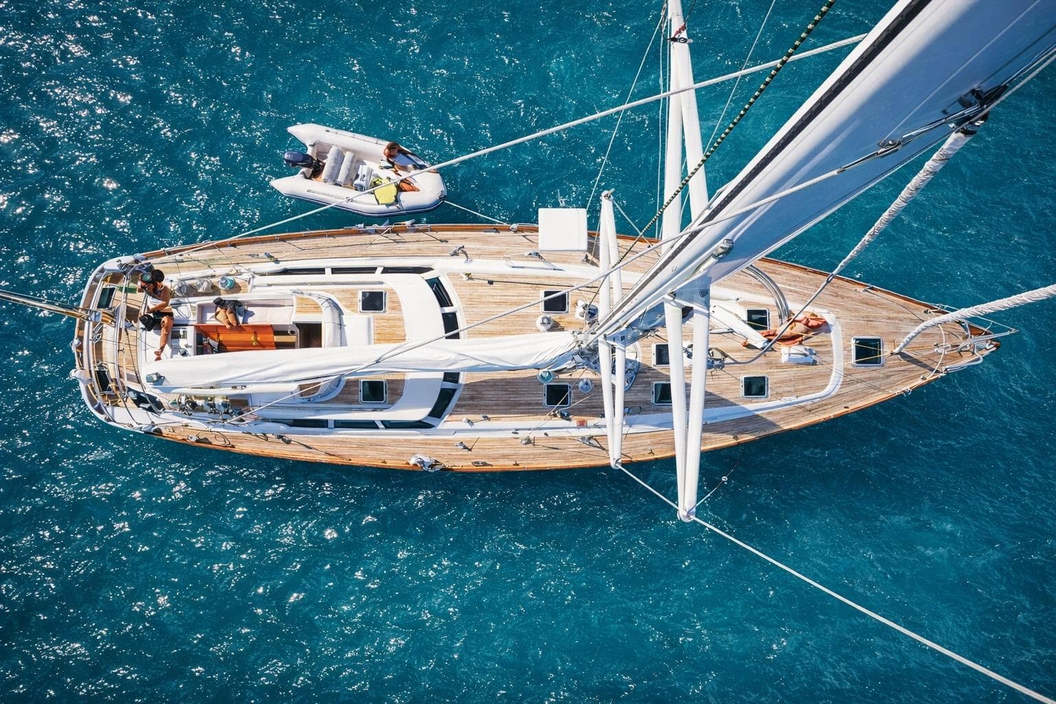 Aerial view of 1993 Oyster 80 Deck Saloon yacht sailing in clear blue waters.