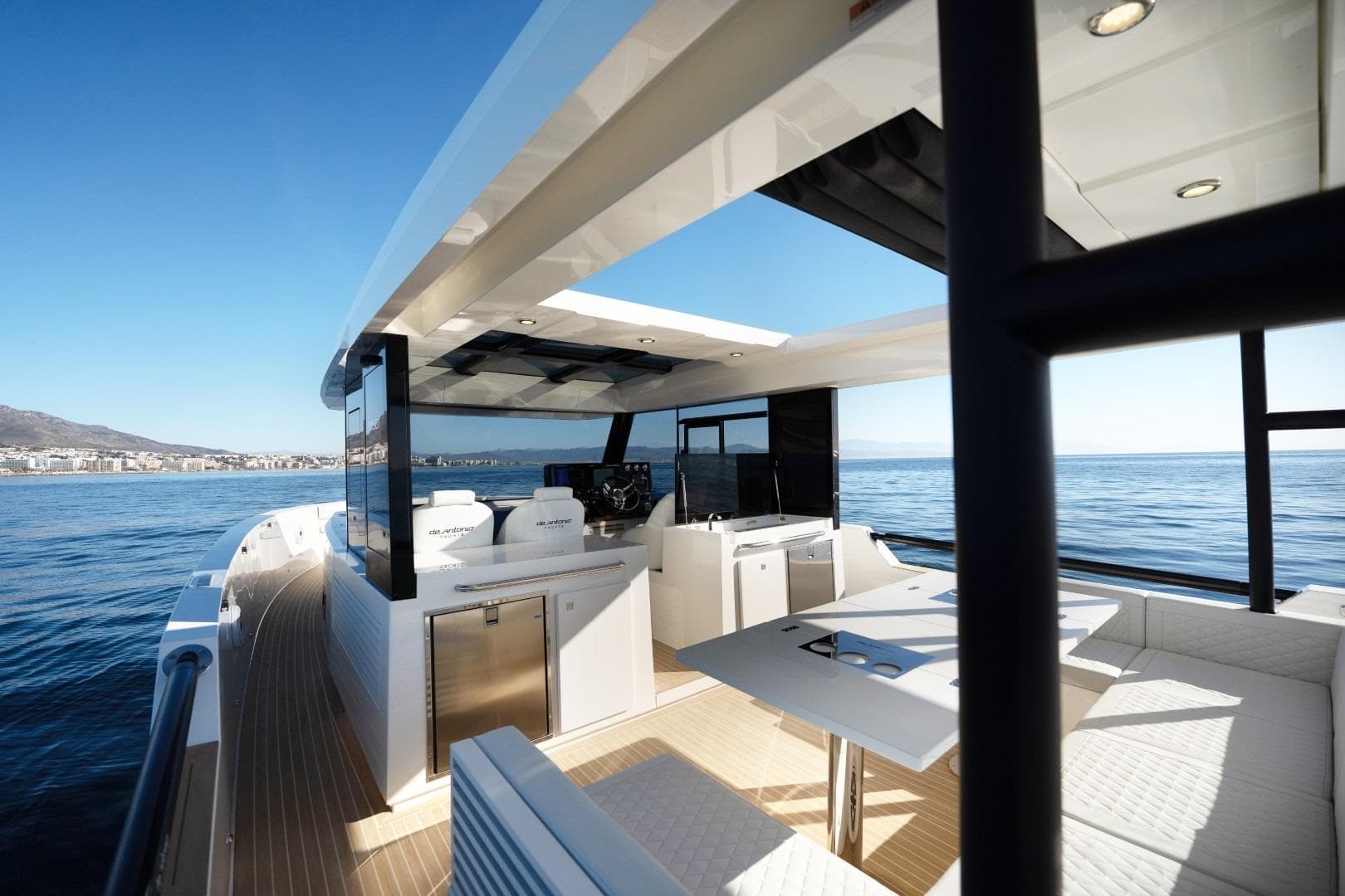 2026 De Antonio Yachts 50 Coupe, luxurious deck view, modern design, open sea backdrop.