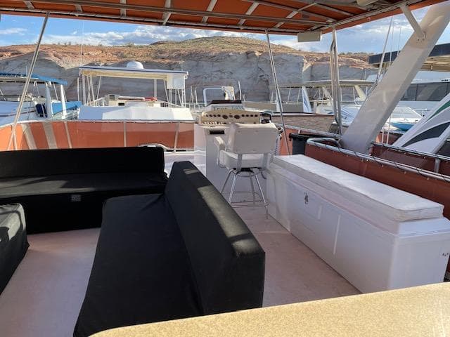 Top deck of 2007 American Waterways Houseboat Sundancer Trip #17 with seating and helm.