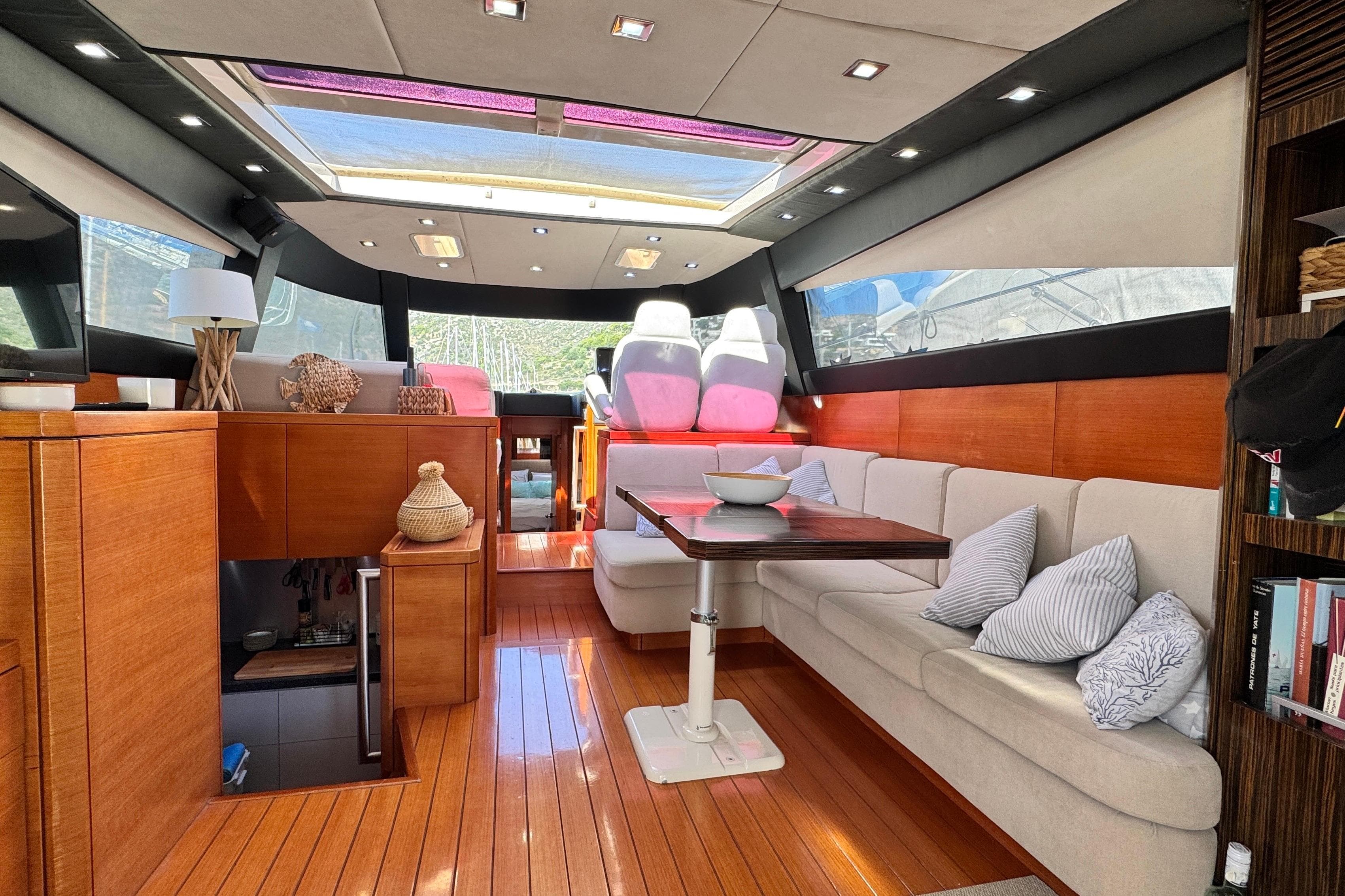 Luxurious interior of a 2007 Doma 5 yacht with elegant wood finishes and plush seating.