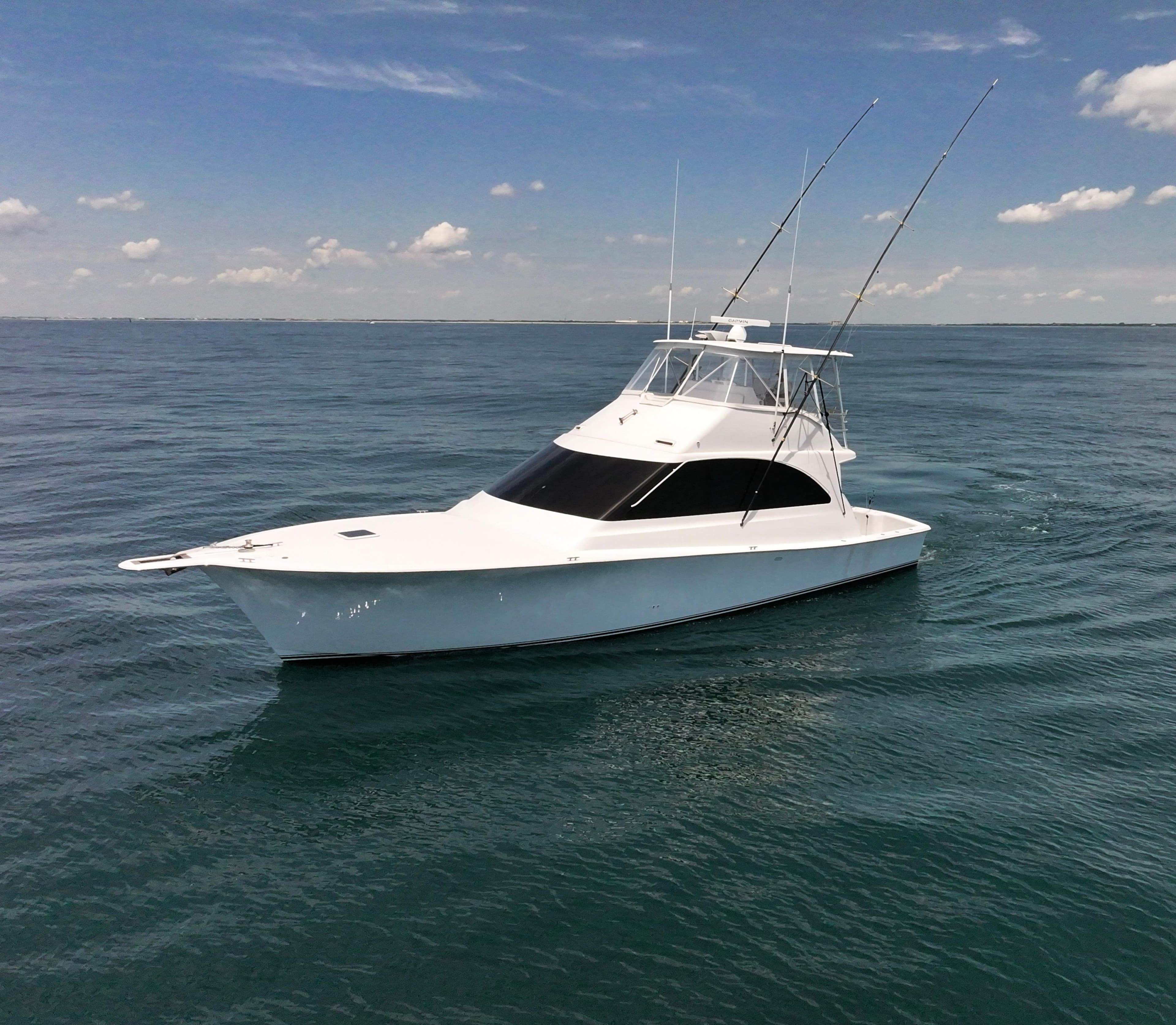 2001 Ocean 52 Convertible yacht on open sea under clear sky.