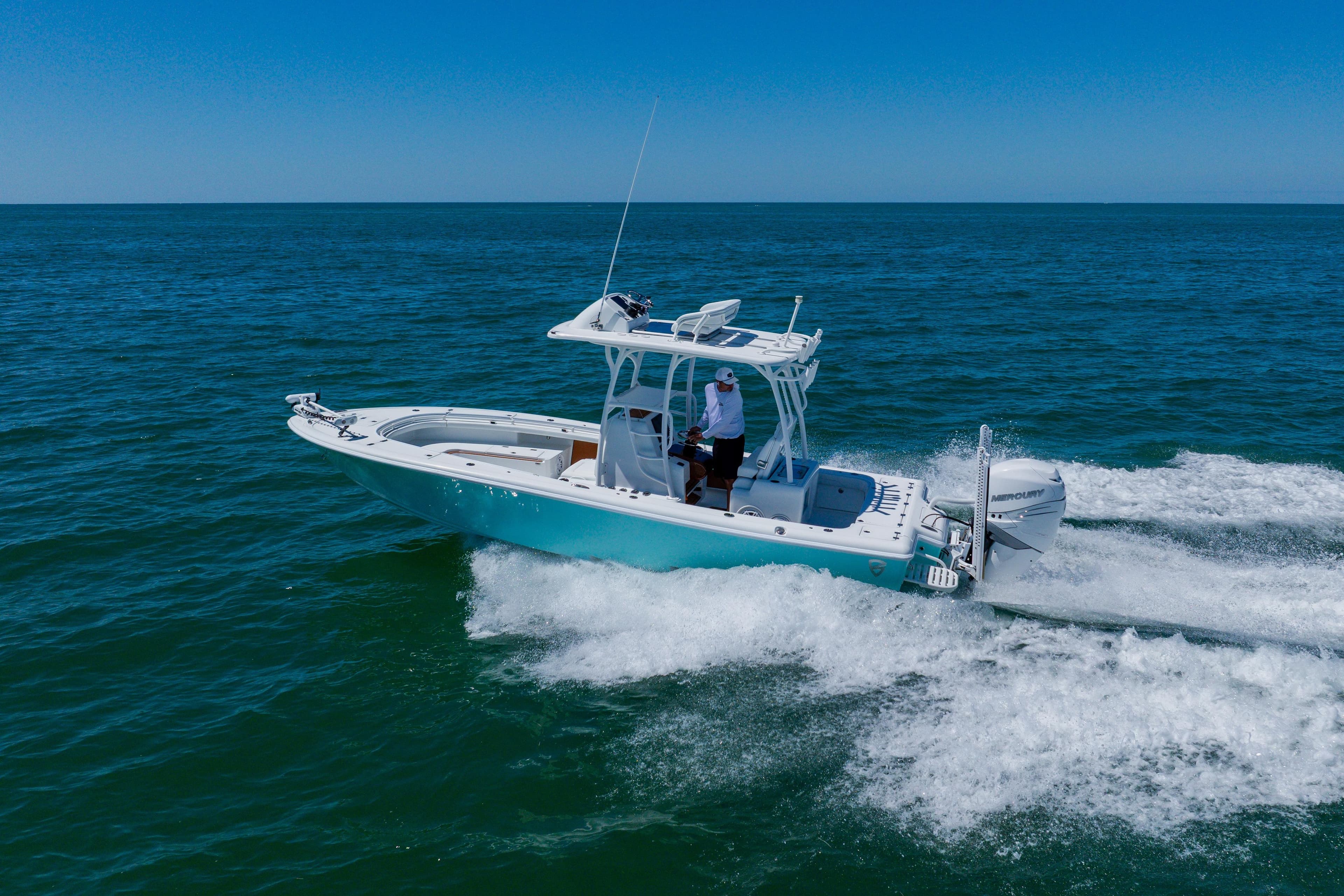 2017 Barker Boatworks 26 cruising on open ocean under clear blue sky.