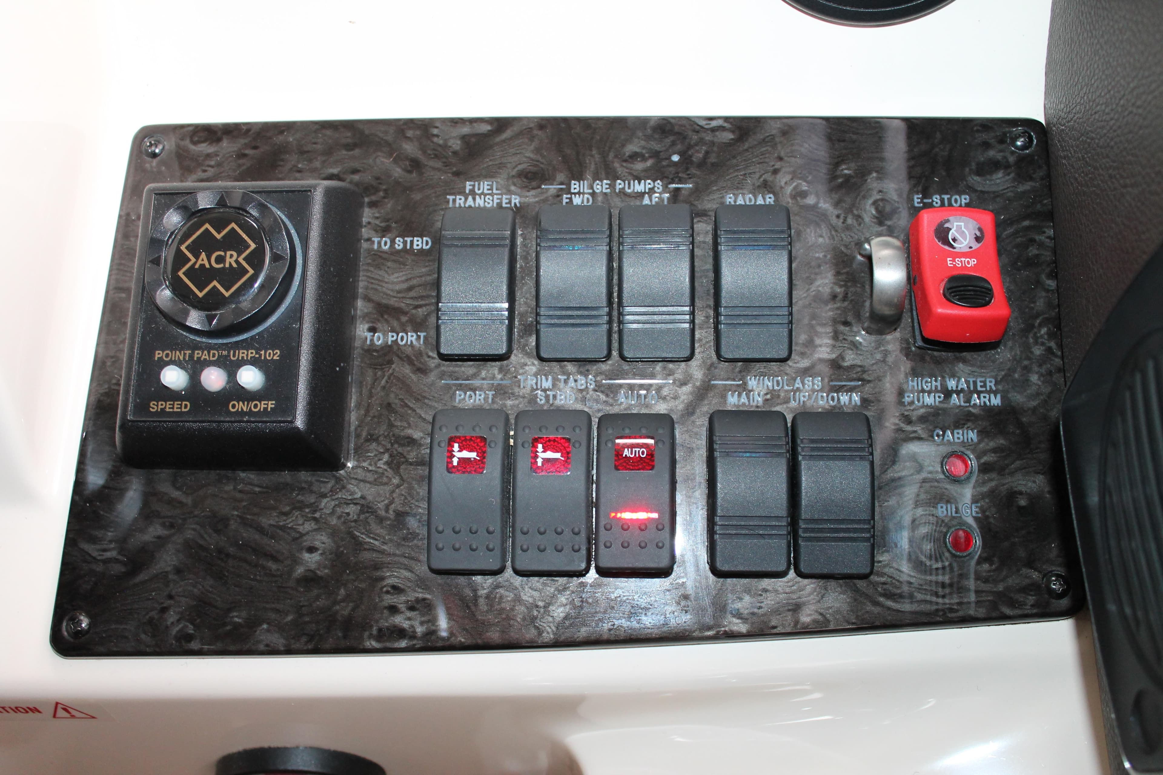 Control panel of a 2015 Sea Ray 470 Sundancer boat with various switches and buttons.