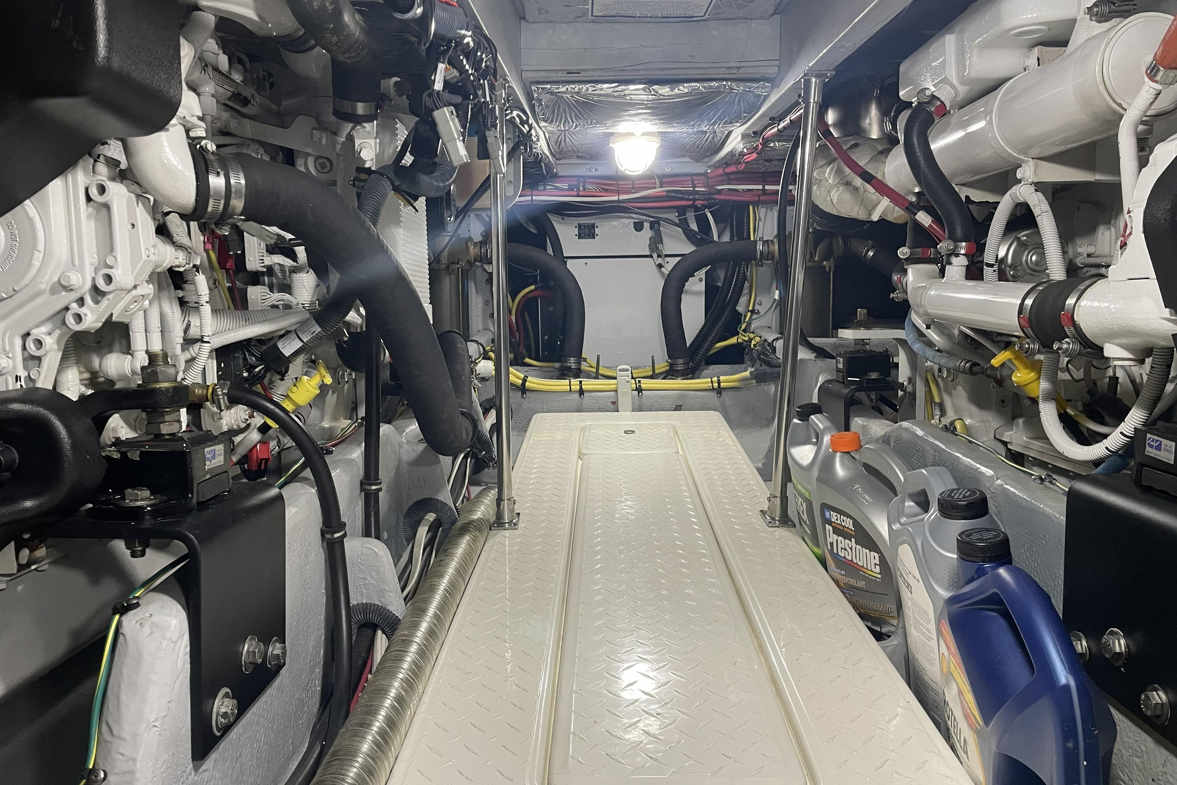 Engine room of a 2008 Meridian 490 Pilothouse yacht, showcasing machinery and maintenance supplies.