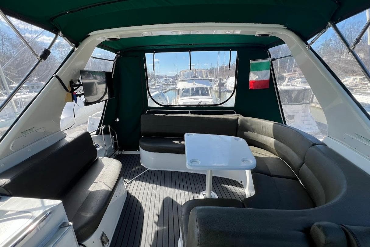 Interior of 2000 Carver 530 Voyager Pilothouse with seating and table, docked at marina.