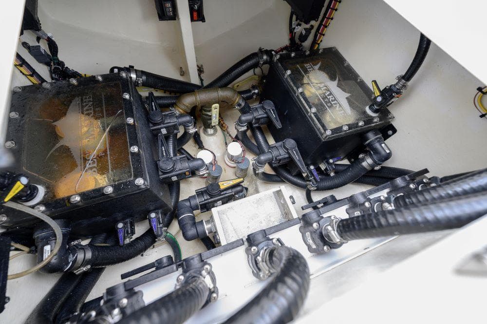 Engine compartment of 2023 SeaVee 420Z boat, showcasing dual engines and complex wiring.