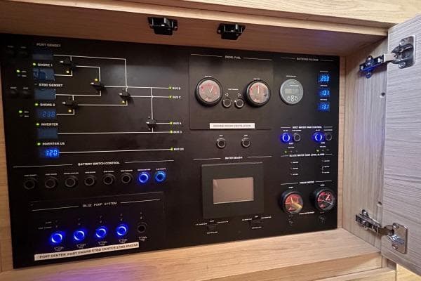Control panel of a 2023 Lagoon Seventy 7 yacht, featuring gauges and switches.