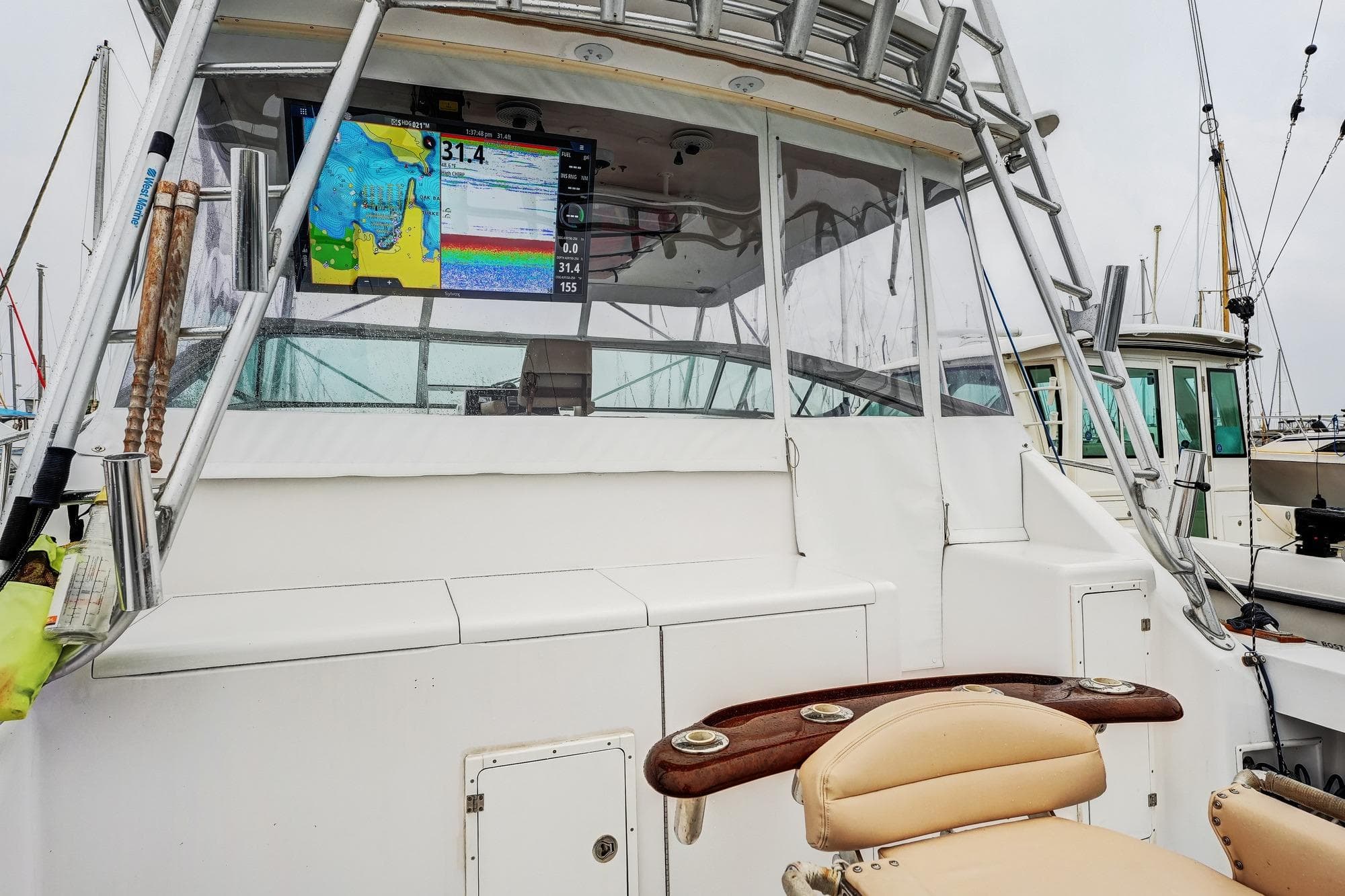 1992 Viking 43 Open boat cockpit with navigation display and fishing chair.