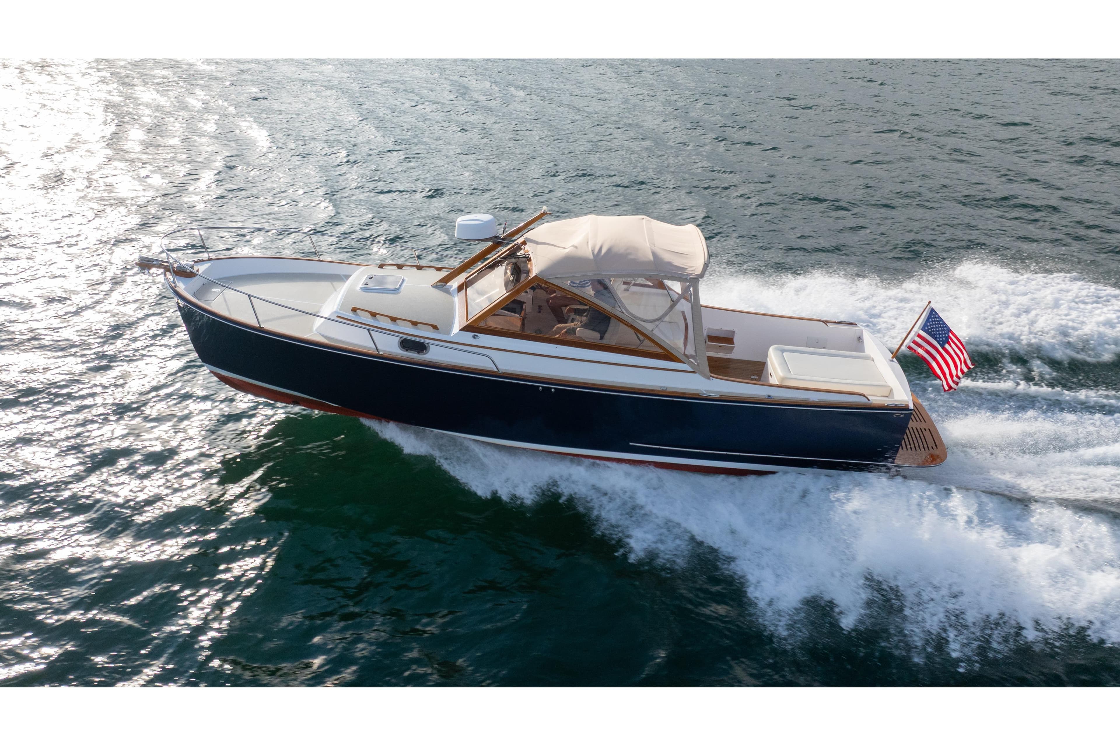 2020 CH Marine Shelter Island Nomad cruising on open water with American flag.