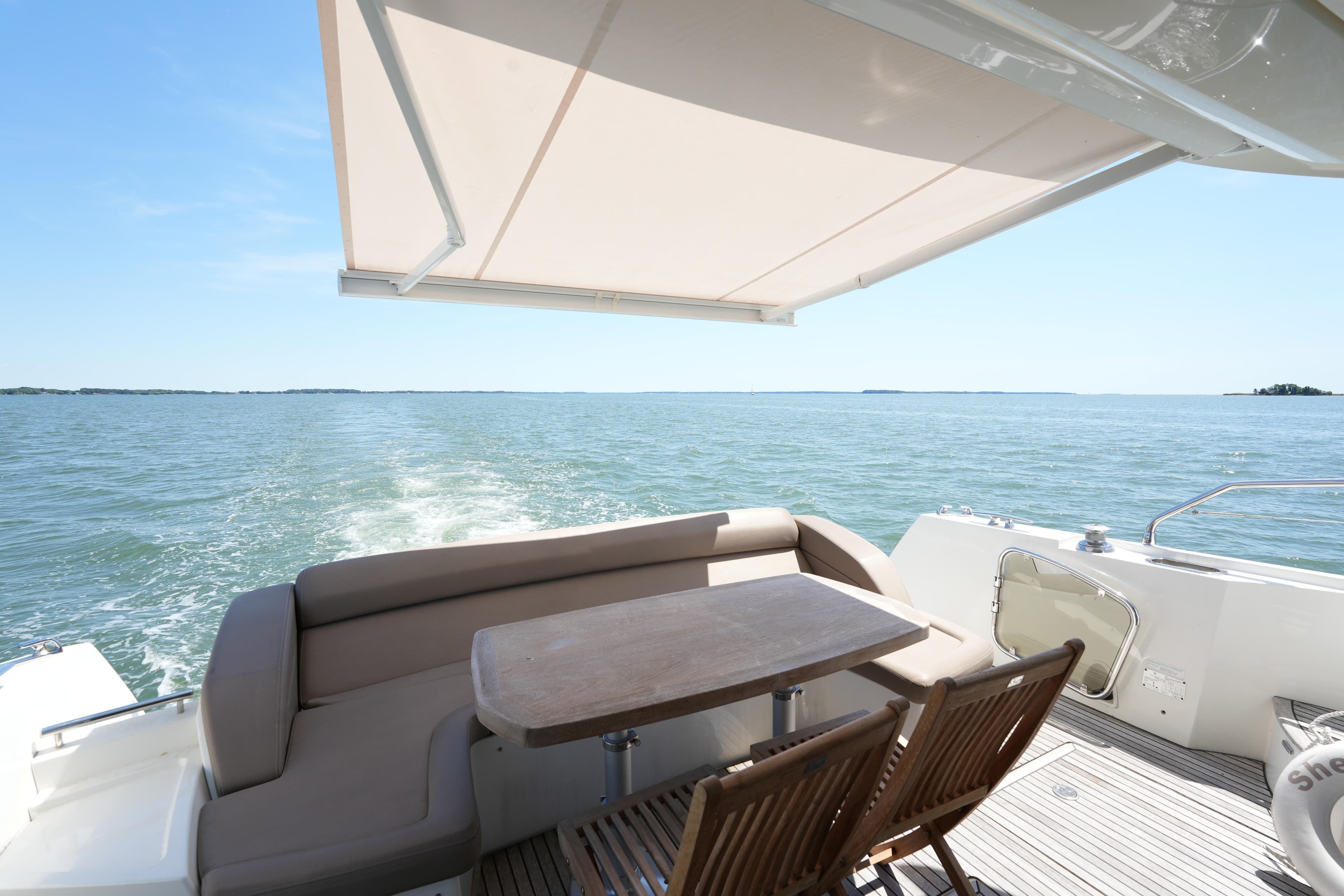 Luxury 2015 Prestige 500S yacht deck with seating, table, and ocean view.